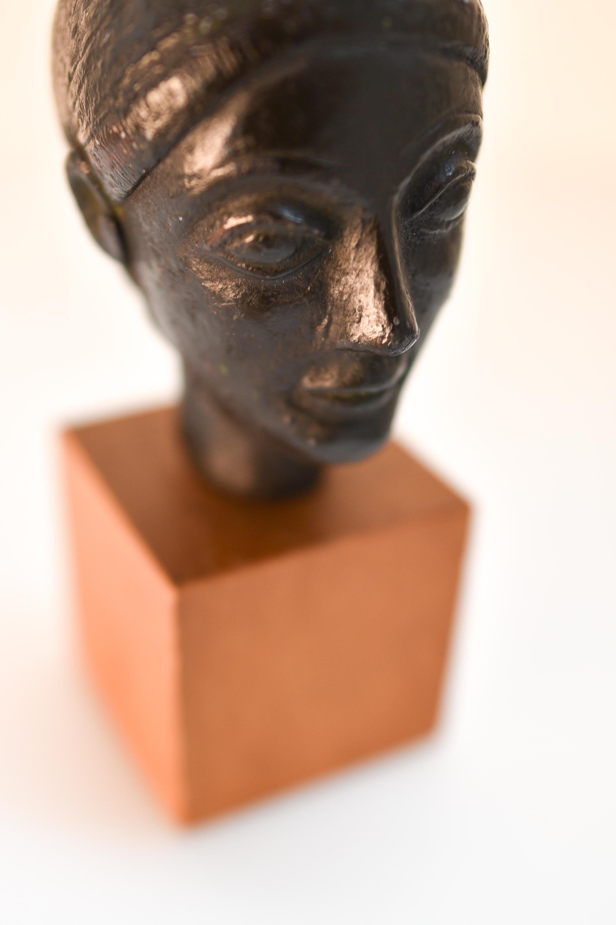 Terracotta 20th century miniature black terracotta head of a woman, mounted on wood