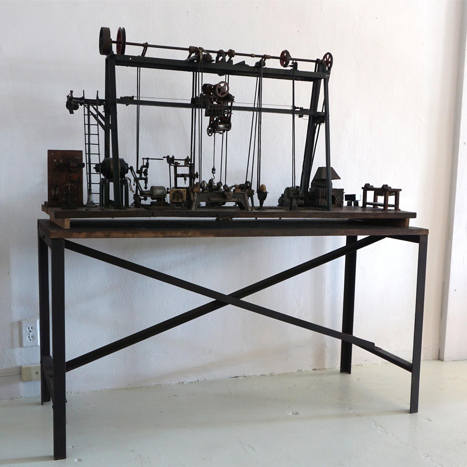 A vintage French model of a miniature industrial machine shop-factory, with oven, a testimony of the industrial revolution (museum quality). Wooden base with simple iron legs is included. The model is in good condition. Wear consistent with age and