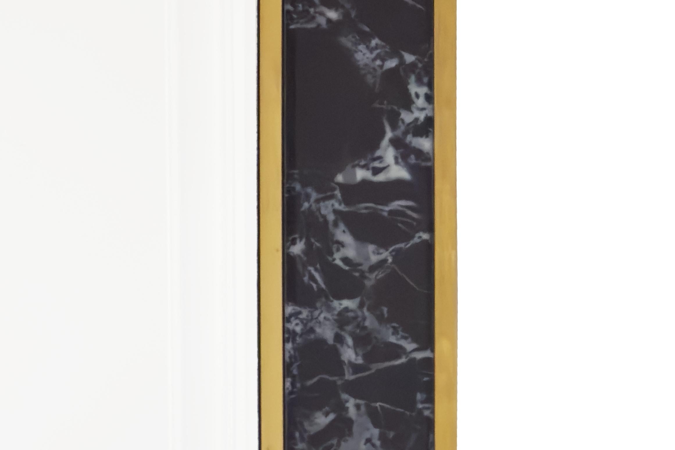 Este espejo cuadrado, grande y elegante, muestra el clásico diseño italiano de los años 80. 
Presenta un llamativo marco de cristal negro efecto mármol, enmarcado con un perfil de latón cepillado que añade un contraste cálido y elegante.
El propio