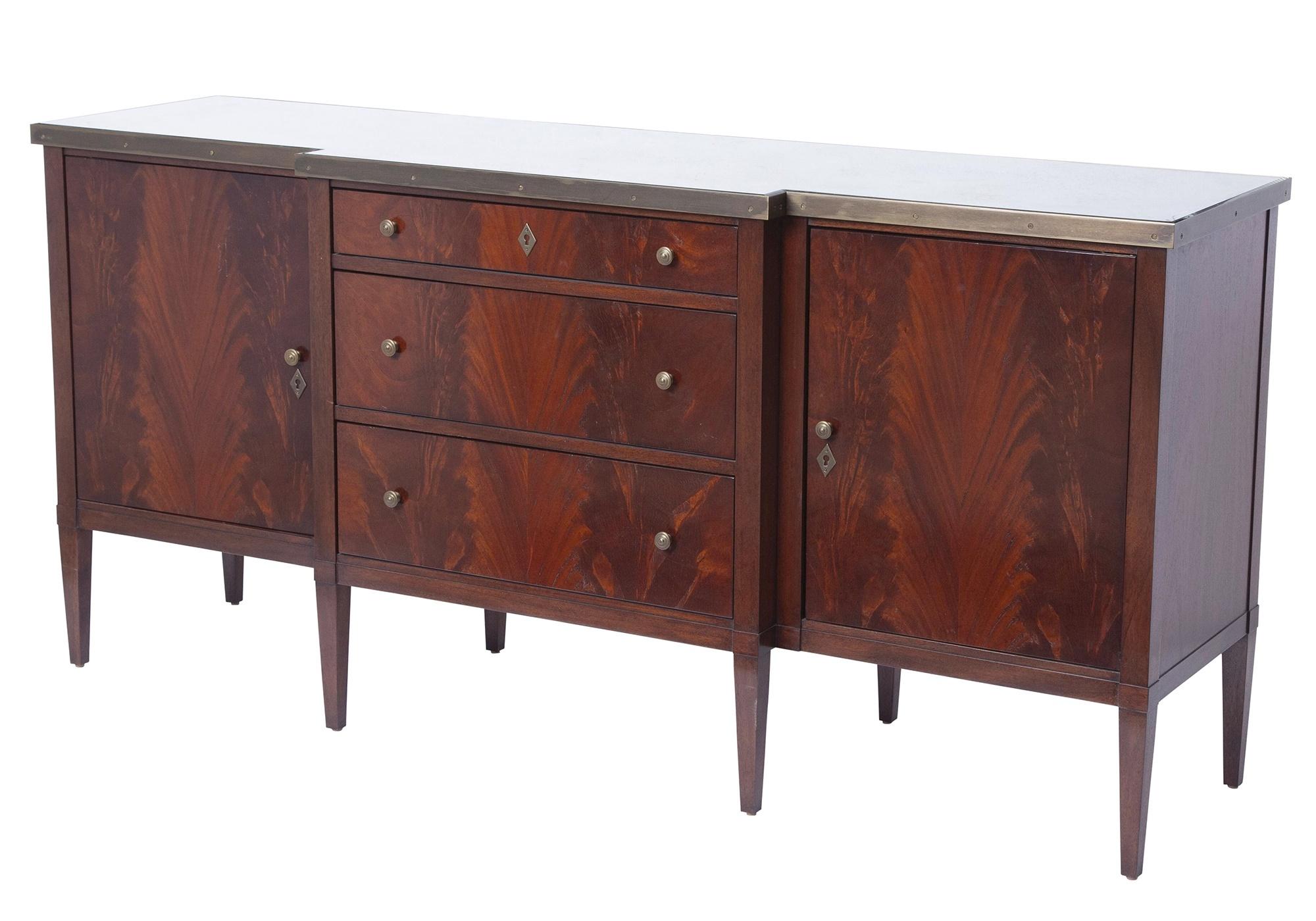 This exquisite sideboard, crafted by the renowned Dessin Fournir company in the mid-20th century, exemplifies superb craftsmanship and elegant design. Constructed from beautifully grained mahogany wood, this piece features brass hardware and a