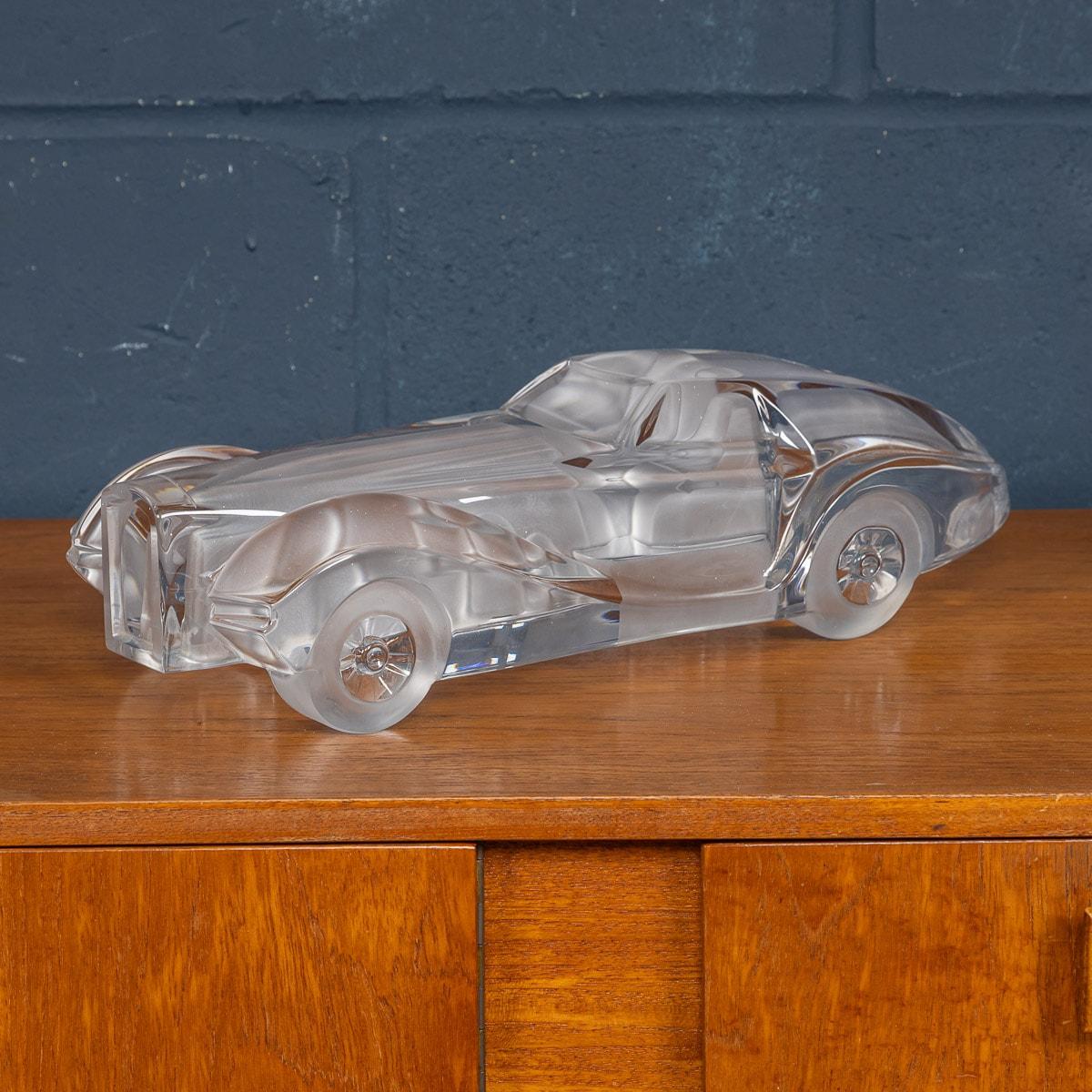 A rare model race car designed by Xavier Froissart and realised by Daum, France, circa 1985. A mixture of frosted and polished glass give a wonderful texture to this sculpture, recalling the lines of a Le Mans single seater race-car from the 1940s.