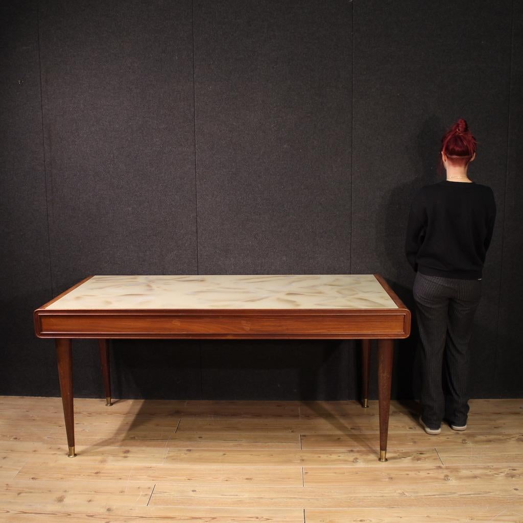 Italian table from the 60s/70s. Finished for the centre furniture from an Italian design of excellent quality in mahogany and fruitwood. Dining room or living room table of excellent size and proportion, supported by four solid conical wooden legs
