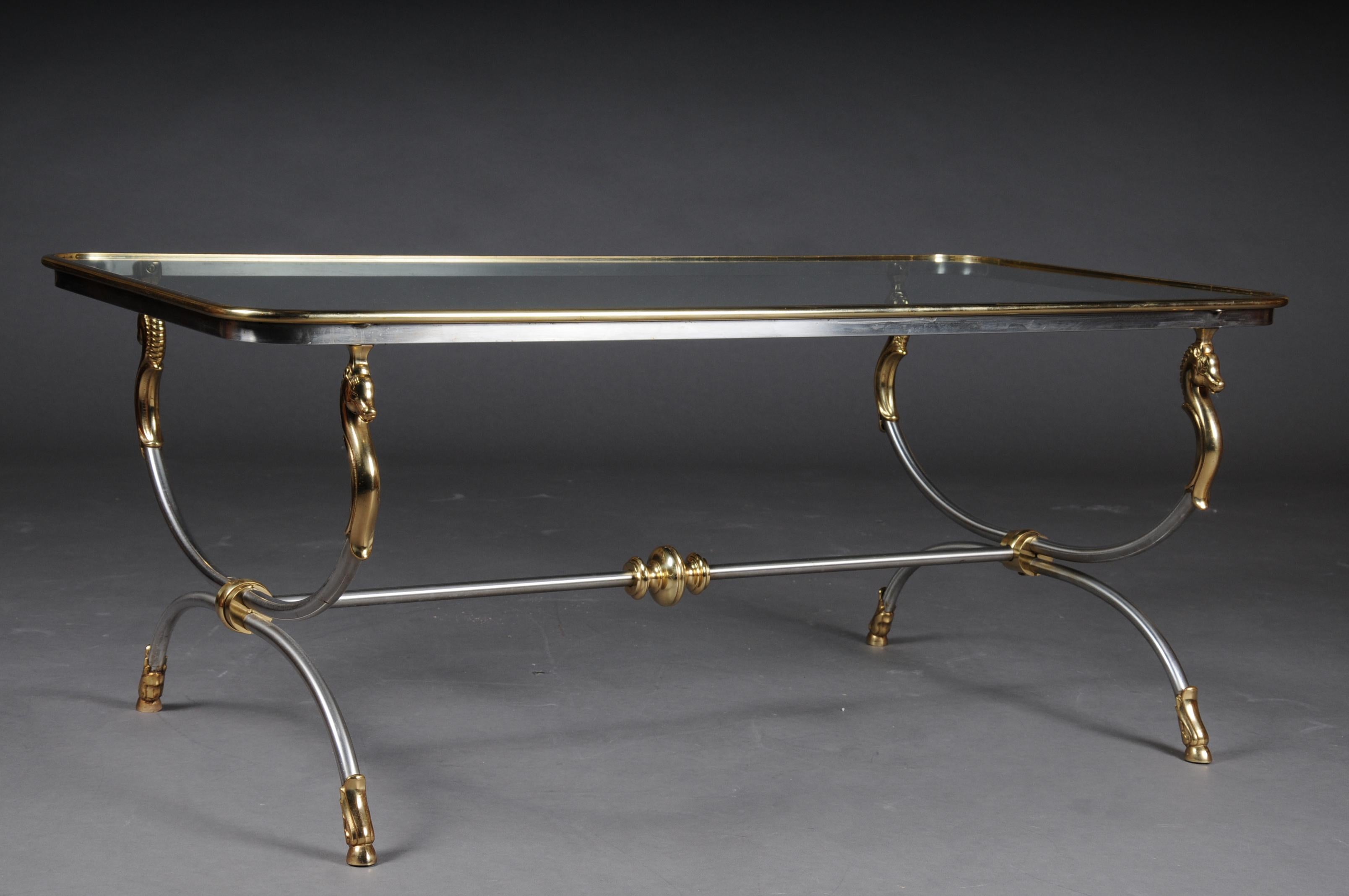 Modern designer coffee table, chrome brass, classical style

Chrome / brass frame, curved and flanked by horse busts in brass. Polished brass frame enclosed in a glass plate.

(A-170).