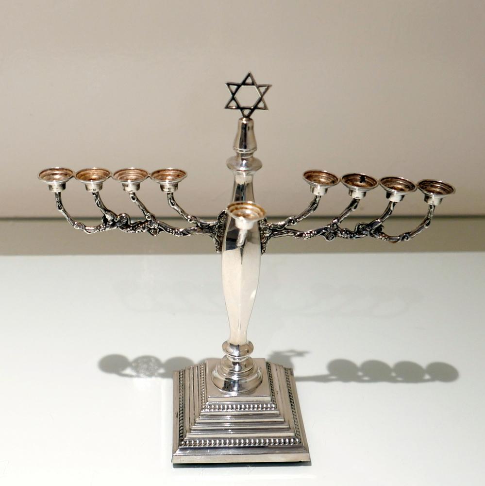 A beautiful and extremely rare model of a modern silver menorah designed with an elegantly creative “naturalistic” branch and bead bordered “stepped” base.

 

Measures: Height 11 inches/28cm

Width 10.5 inches/26.5cm (spread of branch).