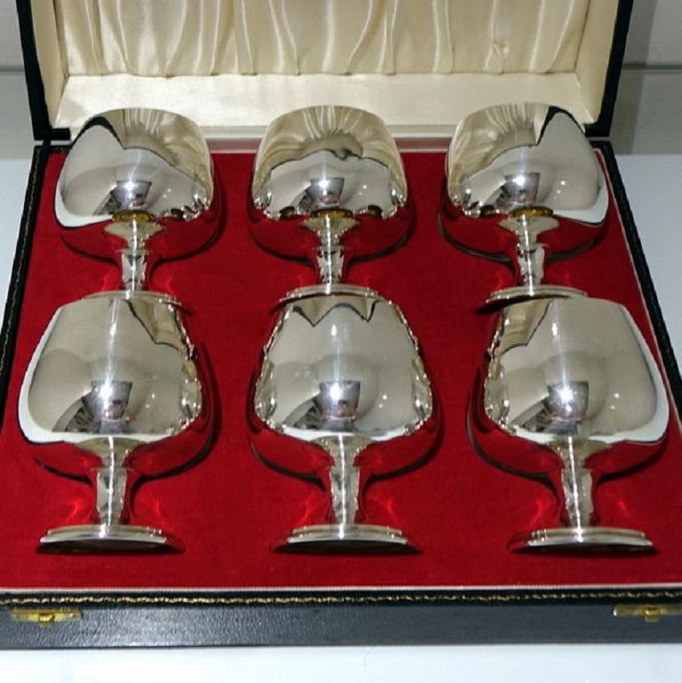 A splendid set of six plain formed sterling silver brandy goblets designed with bulbous bowls and highly visible “featured” hallmarks set in a red and white velvet lined presentation case.