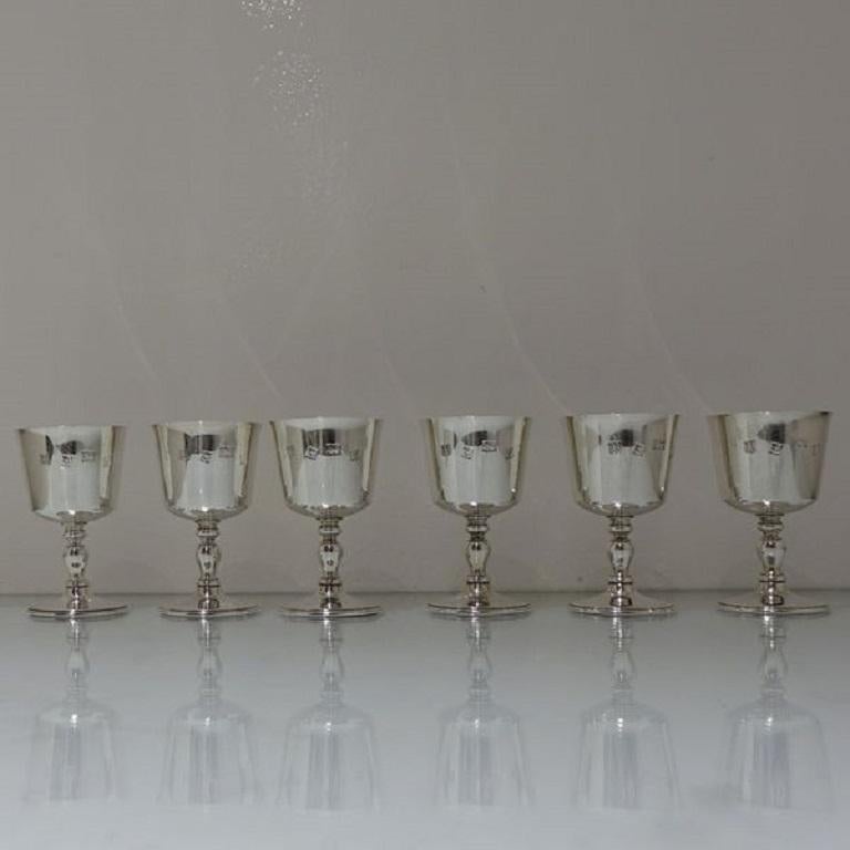 A sweet set of six plain formed silver wine goblets sitting on a raised circular pedestal foot. The bowls of the goblets are centrally hallmarked for decoration. 



Measures: Weight: 26.94 troy ounces/838 grams 

Height: 4.5 inches/11.5cm