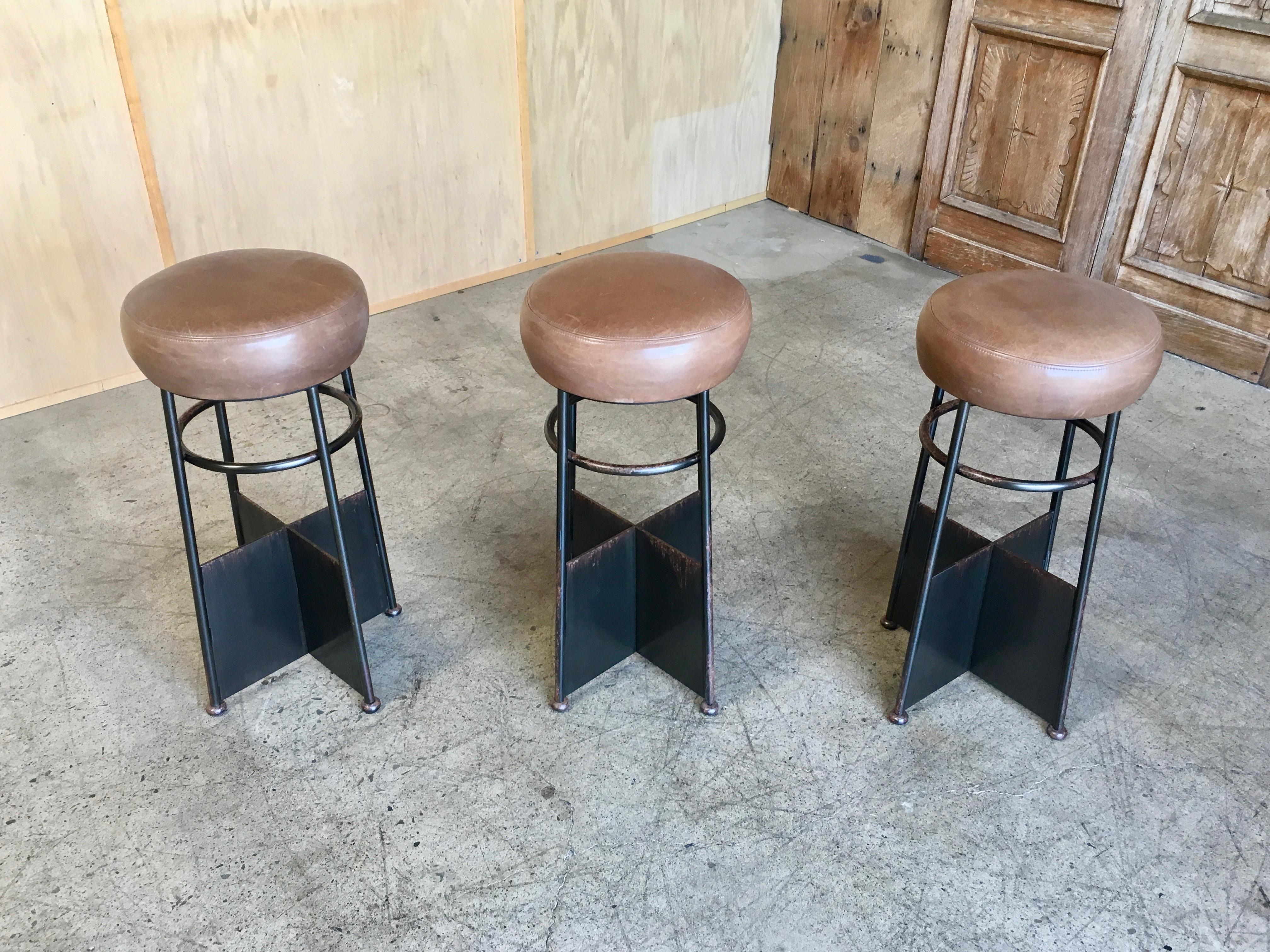 Set of three vintage iron with leather bar stools.