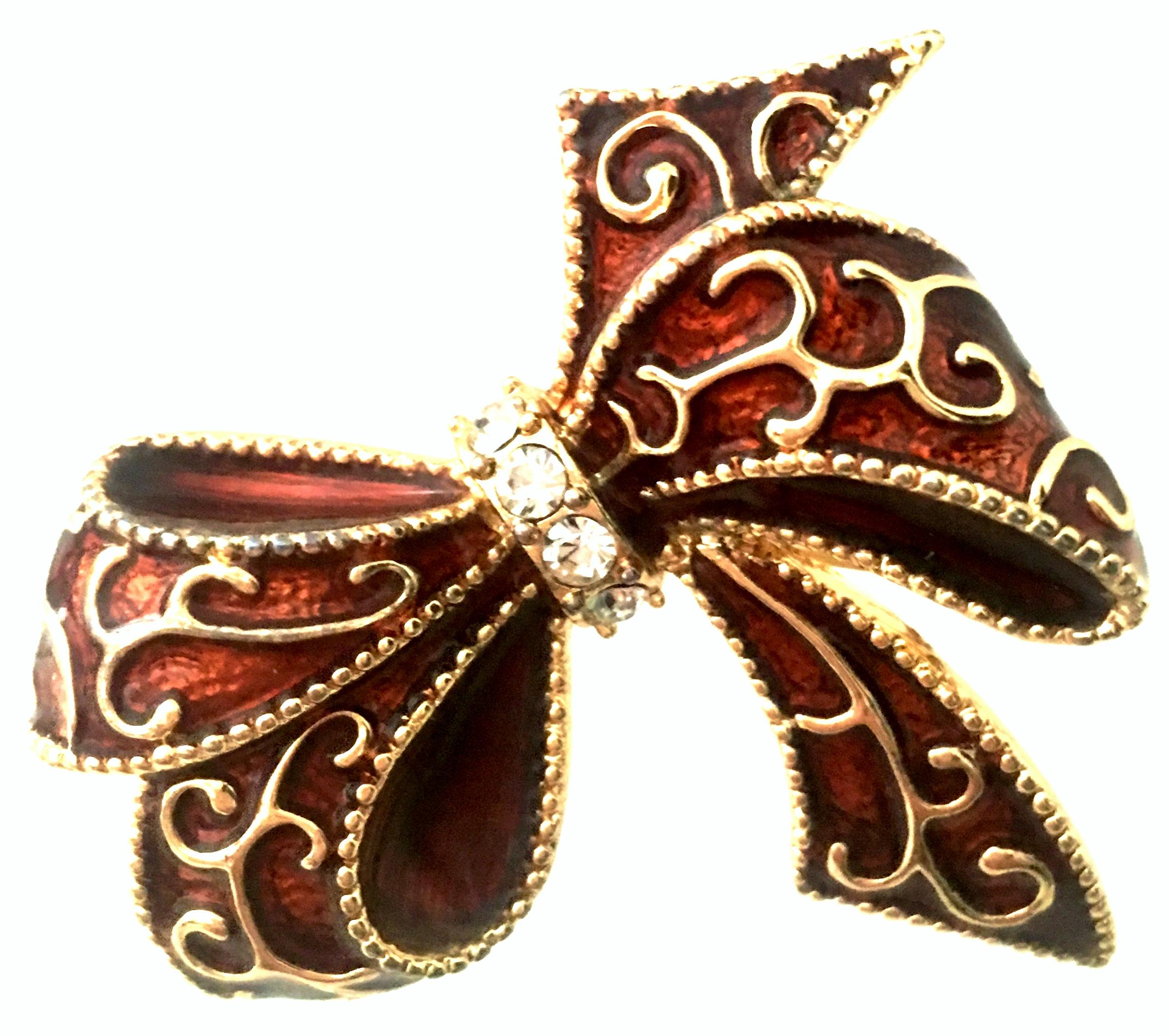 20th Century Gold Plate, Hand Painted Enamel & Austrian Crystal Dimensional Holiday Bow Brooch By, Monet. This finely crafted Monet piece features a abstract dimensional gold plate and hand painted brick red enamel base with applied gold plate