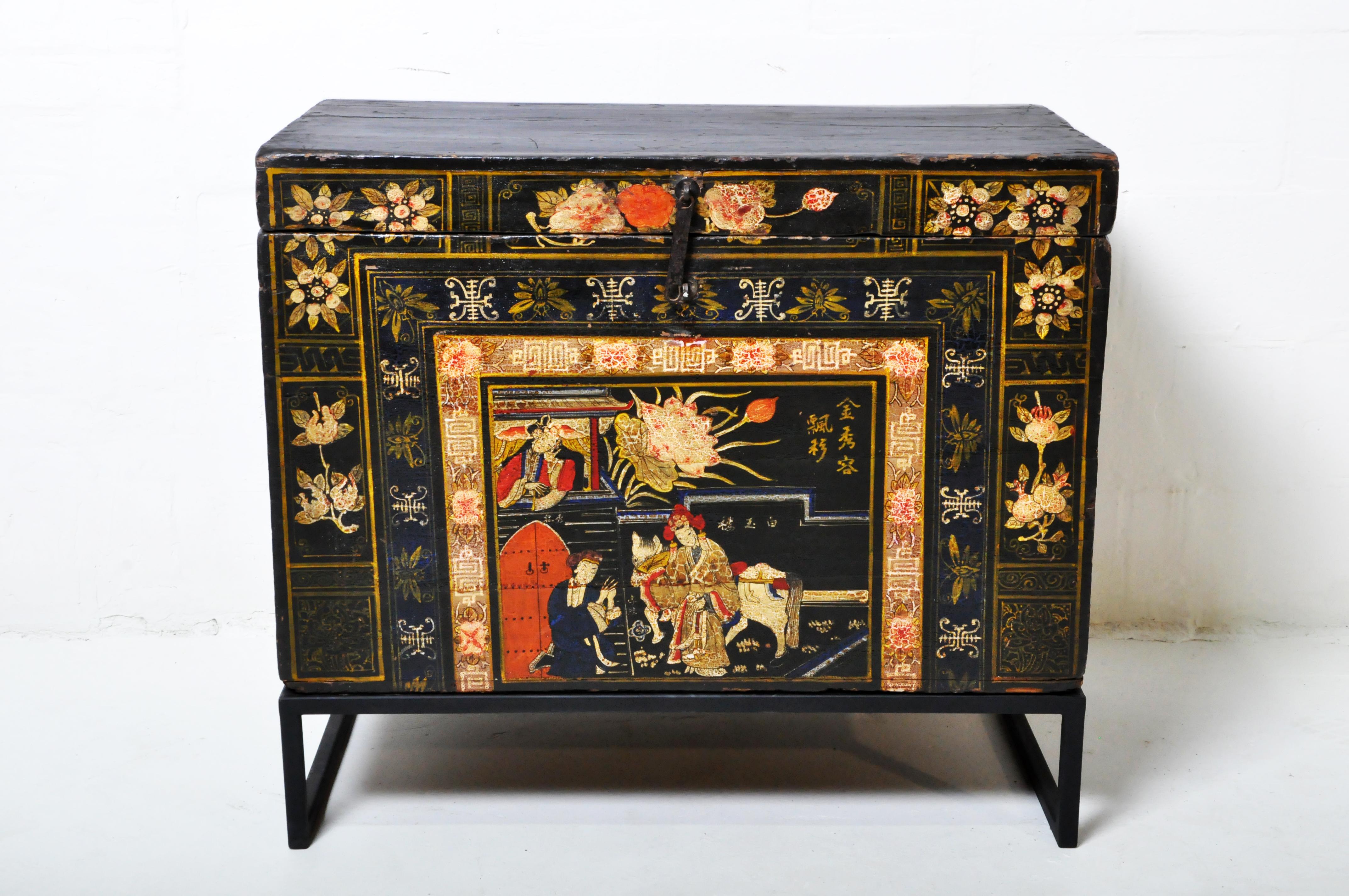 Chinese-Mongolian style wedding chest chest with colorful painting and original patina. The chest was originally used to store blankets. It's raised on a custom metal stand.