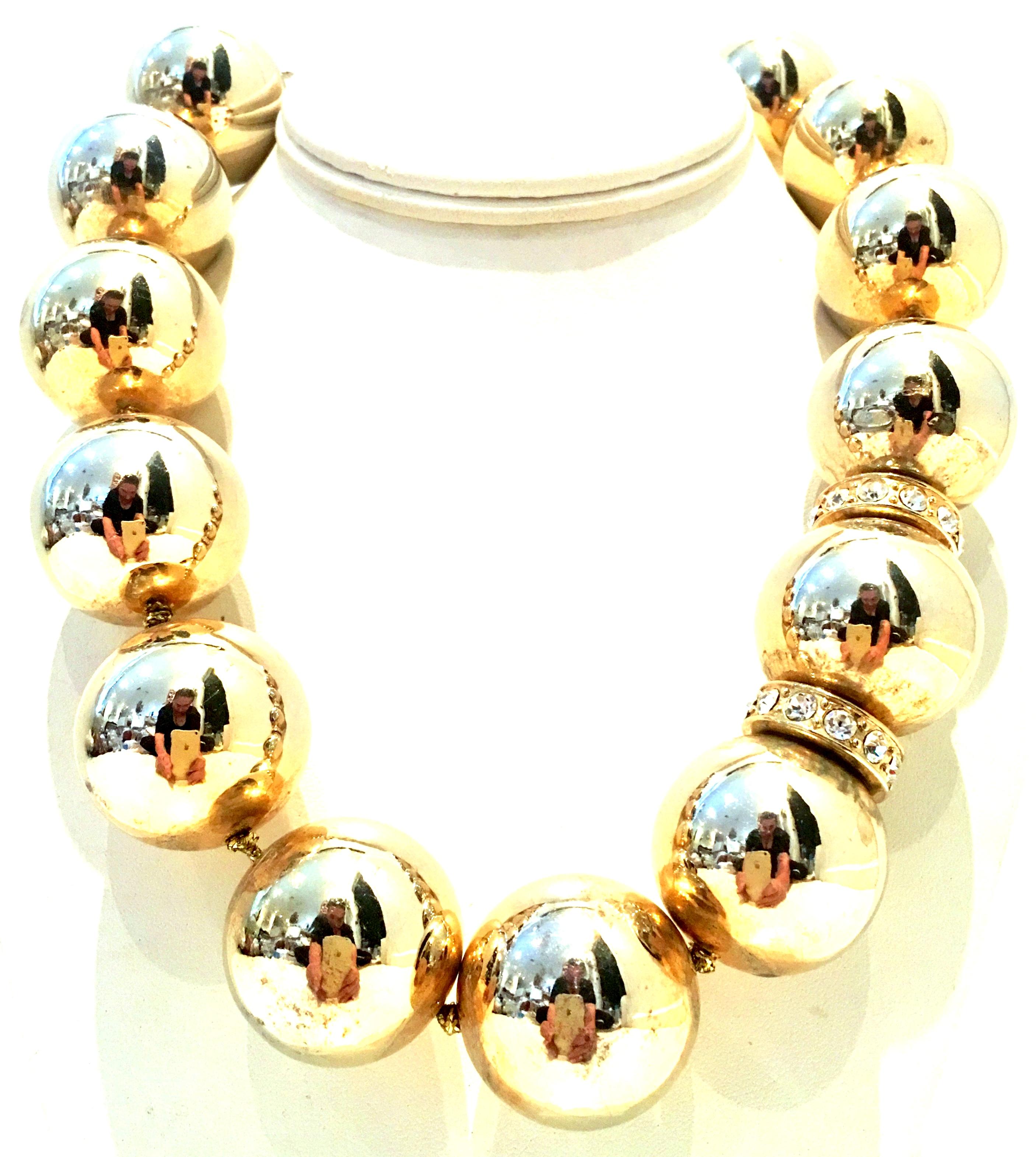 20th Century Monumental Gold Plate Bead & Austrian Crystal Choker Style Necklace By, Lee Angel. This classic, timeless and modernist twist on a monumental gold bead necklace adds a dramatic statement to any occasion. Features huge gold plate beads