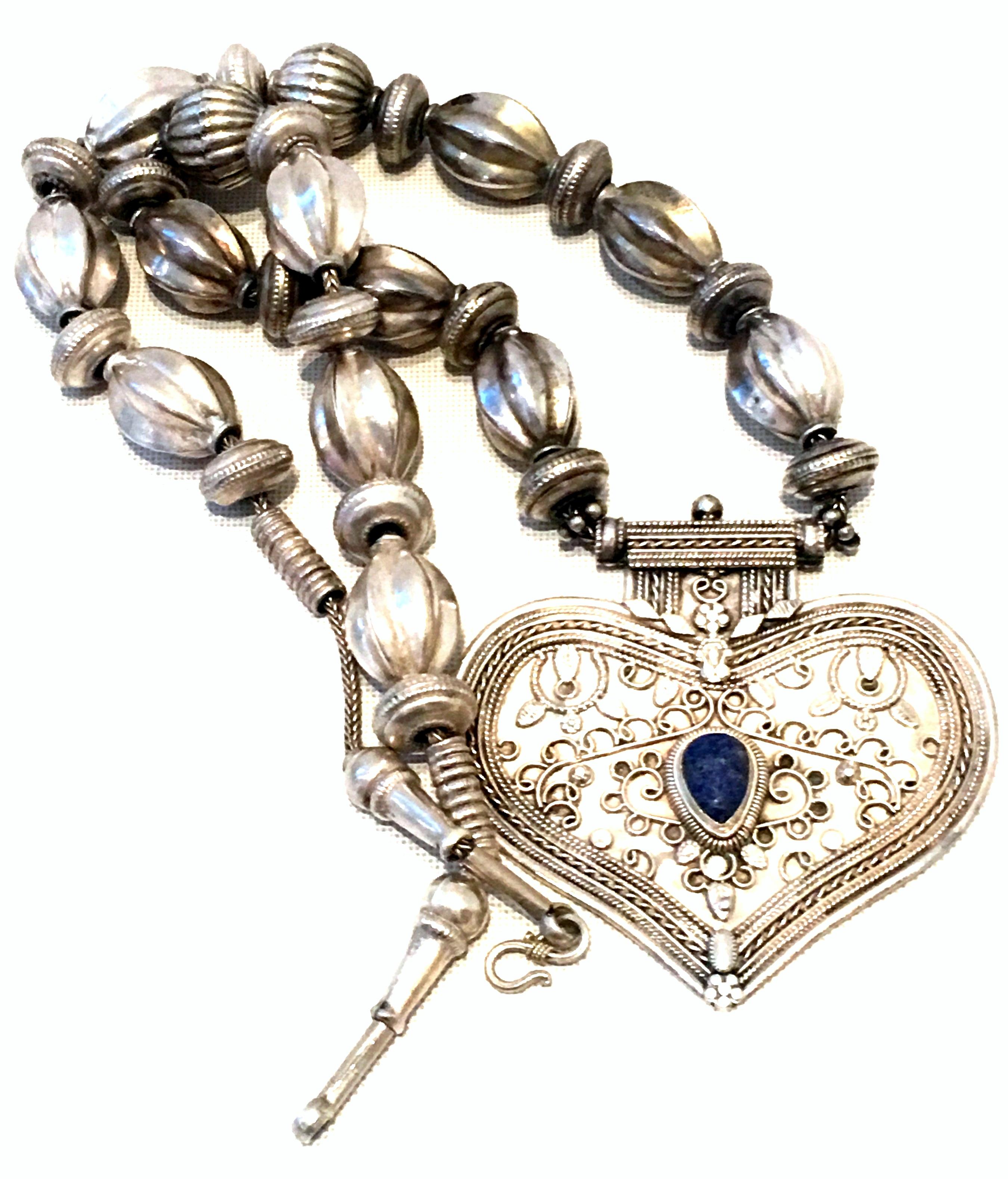20th Century Rajasthan Sterling Silver & Lapis Lazuli Monumental Heart Pendant Necklace. Features organic form large silver beads strung on a silver necklace with a monumental hear form pendant with a central Lapis Lazuli stone. Heart pendant,