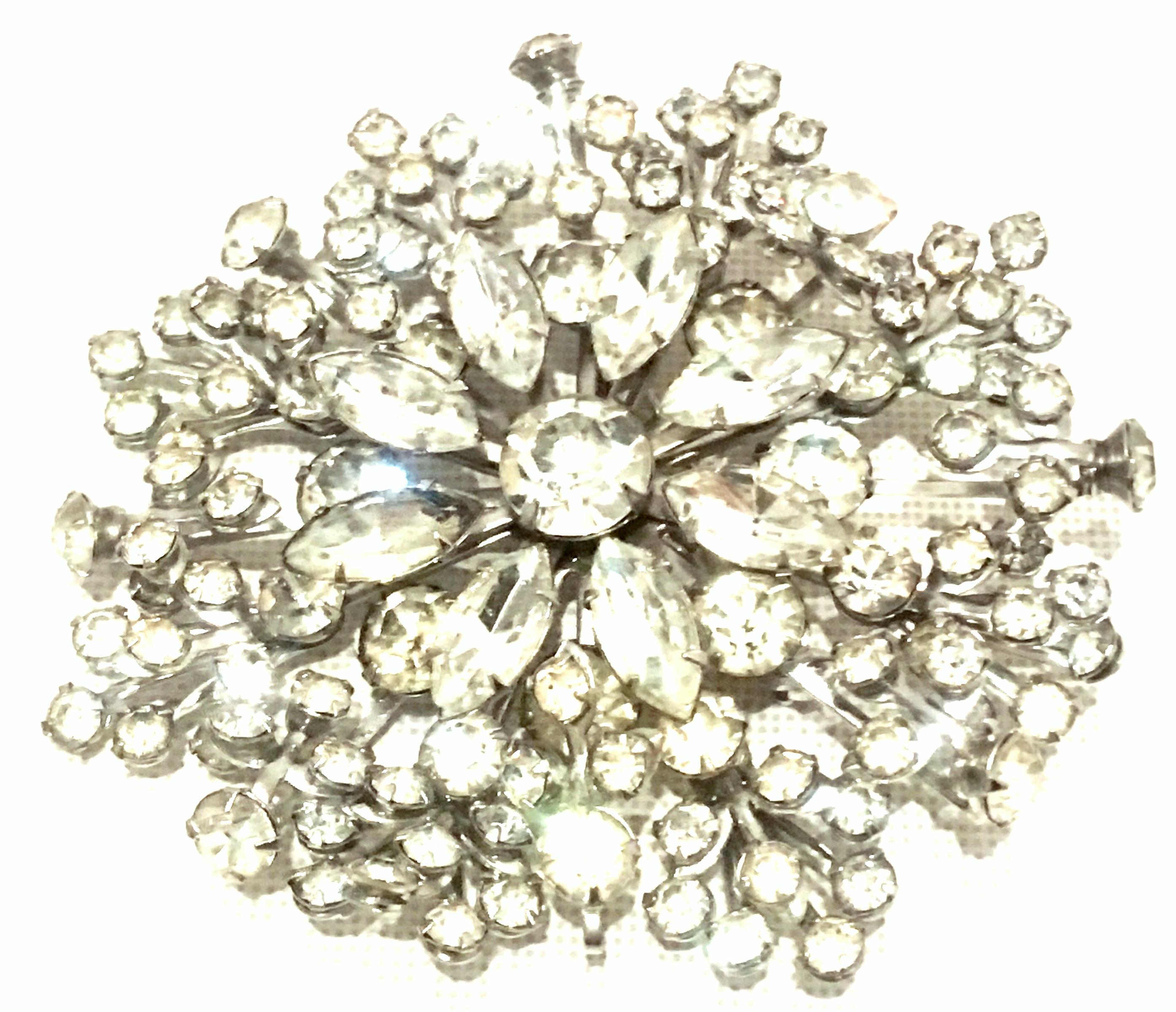 20th Century Monumental Silver & Austrian Crystal Dimensional Brooch This huge silver plate with brilliant cut and faceted colorless Austrian crystal prong set stones features a multi dimensional floral or snowflake burst motif. 