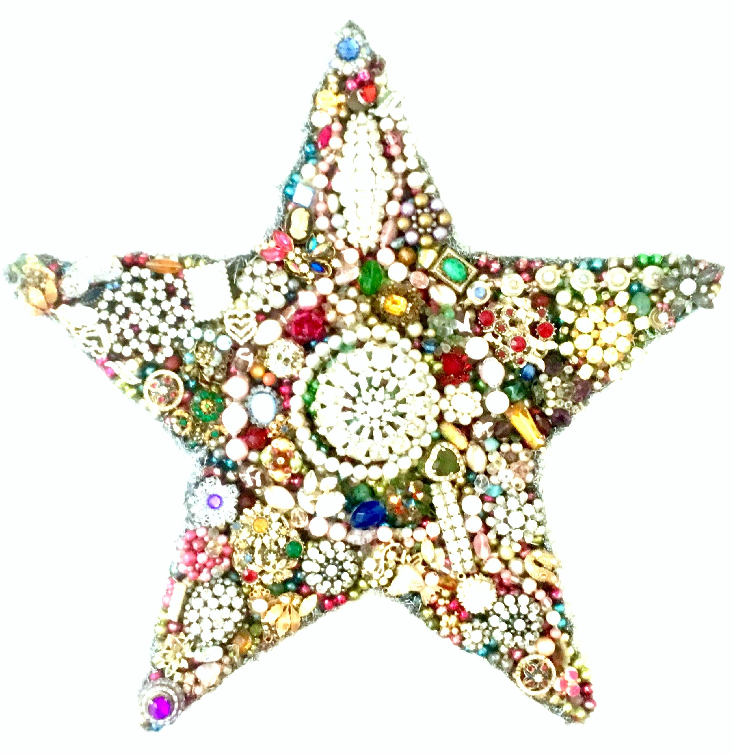 Mid-20th Century Monumental Vintage Costume Jewelry  Hand Crafted & One Of a Kind “Star” Sculpture. Features 100’s of repurposed vintage costume jewelry pieces hand applied to an abstract star sculpture. The underside is backed in steel with wood