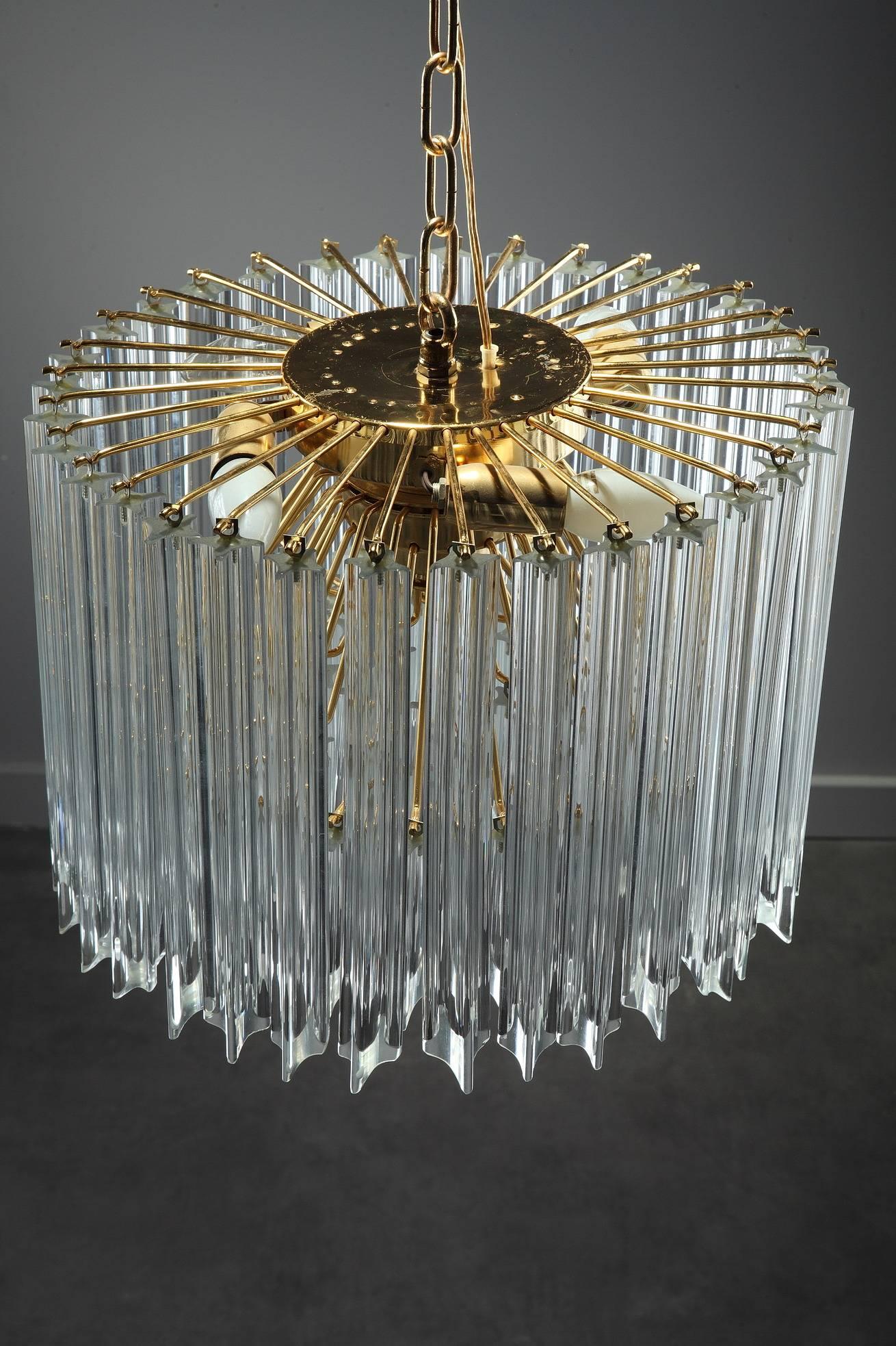 Circular chandelier designed by Paolo Venini for Murano in the 1970s, with long glass crystals on gilded metal mounts. It has 4-light bulbs. Complete, 

circa 1970
Dimensions: W 15.7 in, D 15.7 in, H 35.4 in.
Dimensions: L 40 cm, P 40 cm, H 90