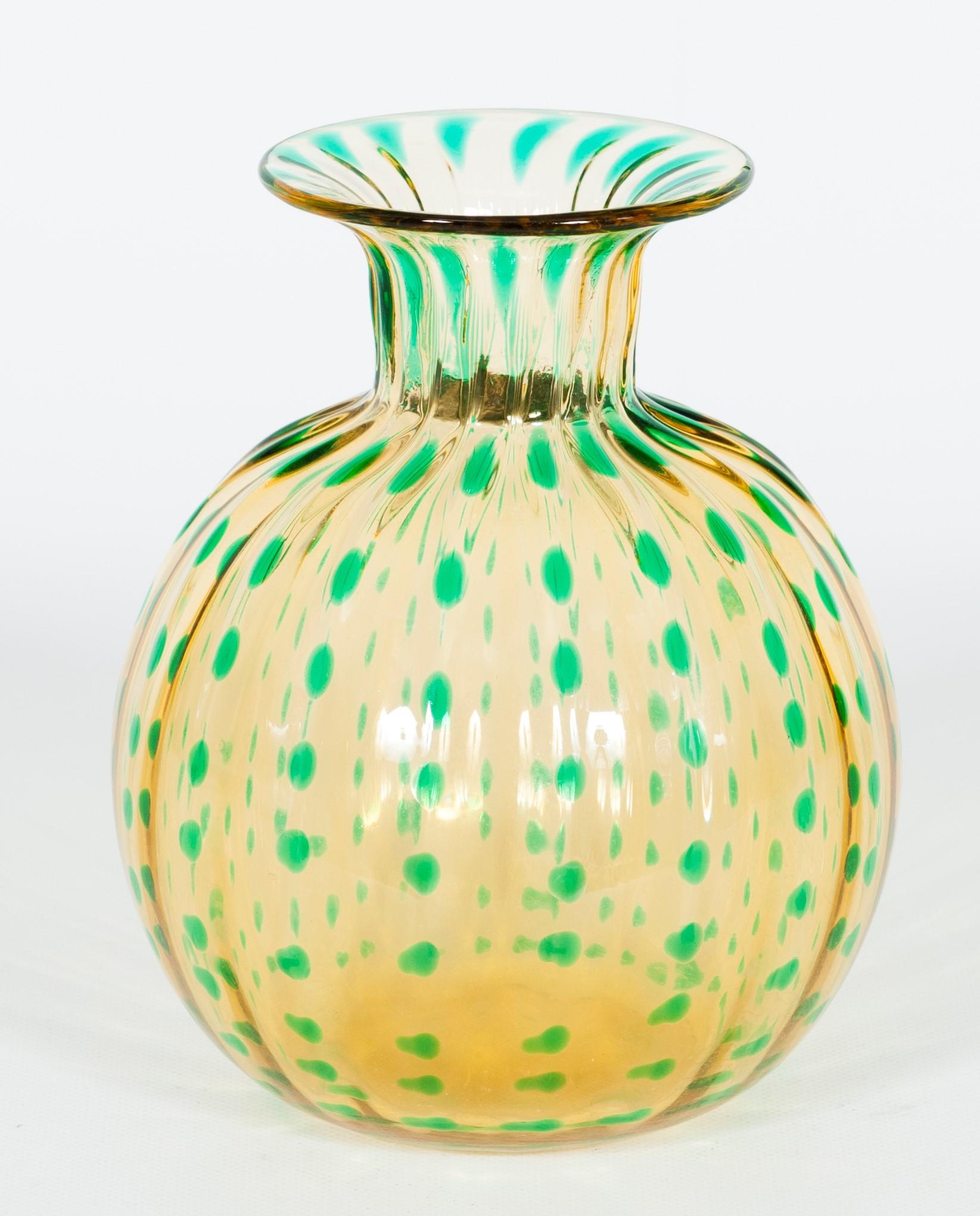 20th century Murano glass round vase with green flecks, Attributed to Caramea.
This beautiful amber color vase was entirely made in the island of Murano in the 1990s, and it is attributed to the renowned Italian maestro Carlo Tosi, also known as