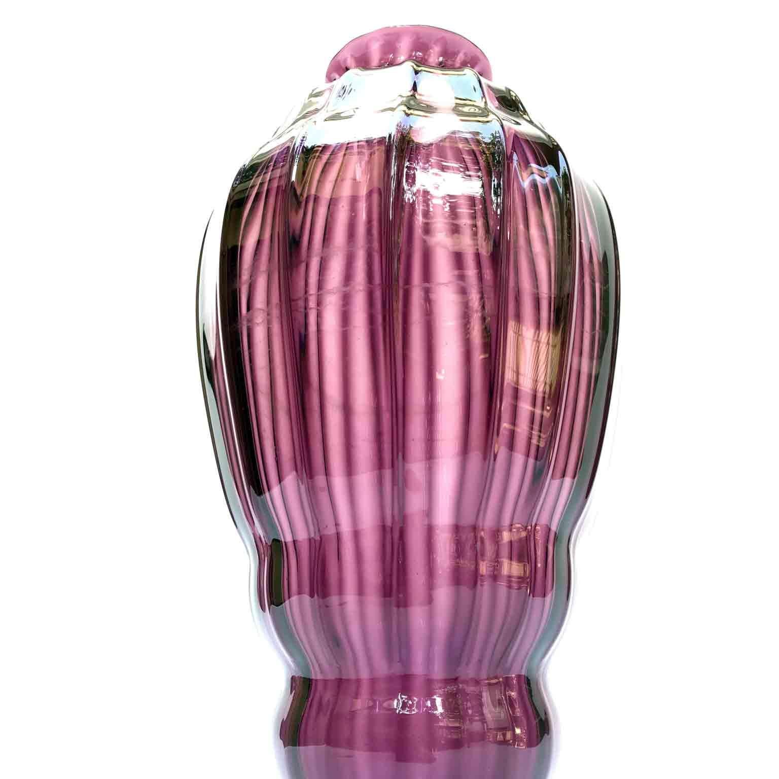 20th century Italian blown glass vase with amethyst colored circular body, fine vertical rib decoration and resting on a circular base. Unsigned.

The body of this antique Venetian violet glass vase has an unusual shaped form. 
It comes from a