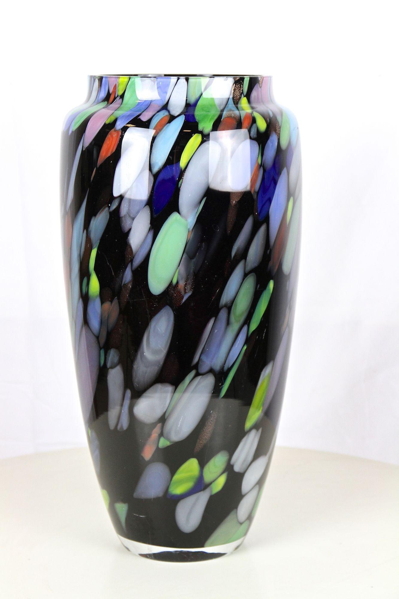 Outstanding looking, multicolored large Murano glass vase from the late 20th century around 1975 in Italy. This beautifully shaped, super dark purple, actually black looking glass body impresses with a very nice contemporary so-called 