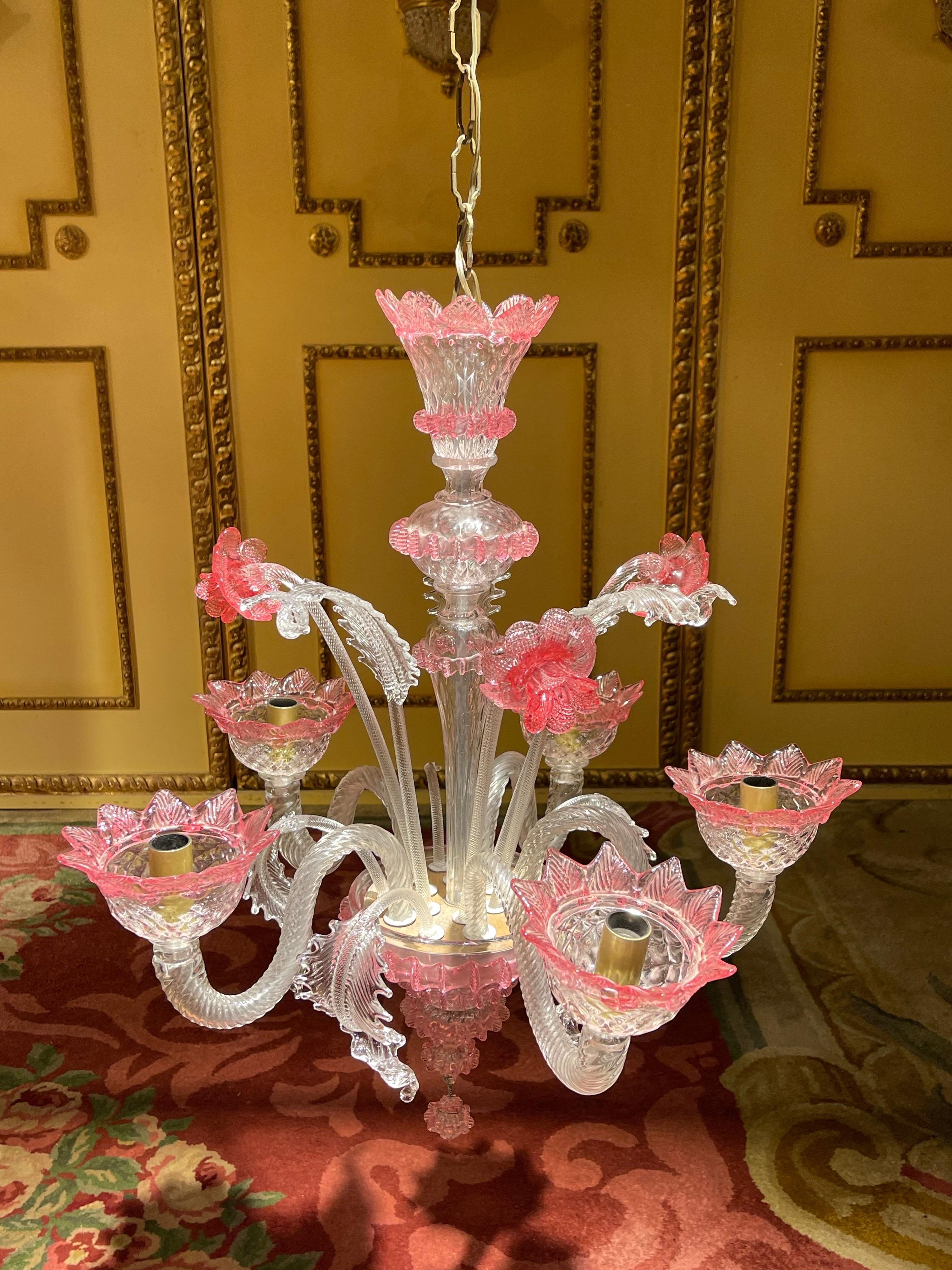 20th century Louis XV style Murano Italy chandelier ceiling luster

Antique Murano chandelier ceiling luster, Italy.
five-flame colorless glass with colorful powder melt. Central baluster surrounded by plastic flowers and foliage, as well as five