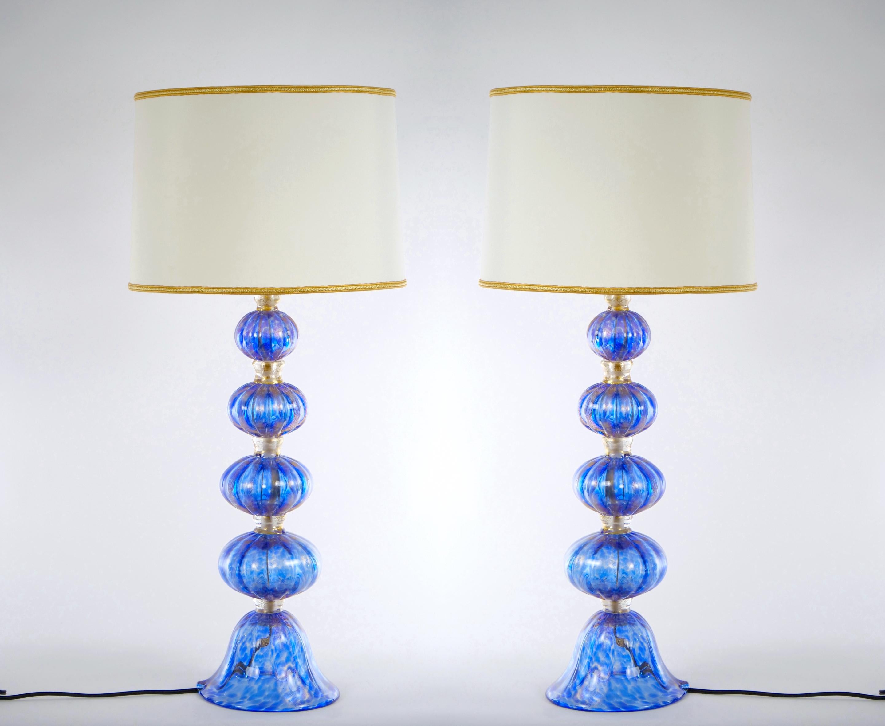 Late 20th century Murano, Venetian hand blown glass and decorated with gold flecks design details pair table lamps. Each lamp have four hand-blown pieces held together by avventurina glass rings, fused with 24-carat gold flecks resting on an open