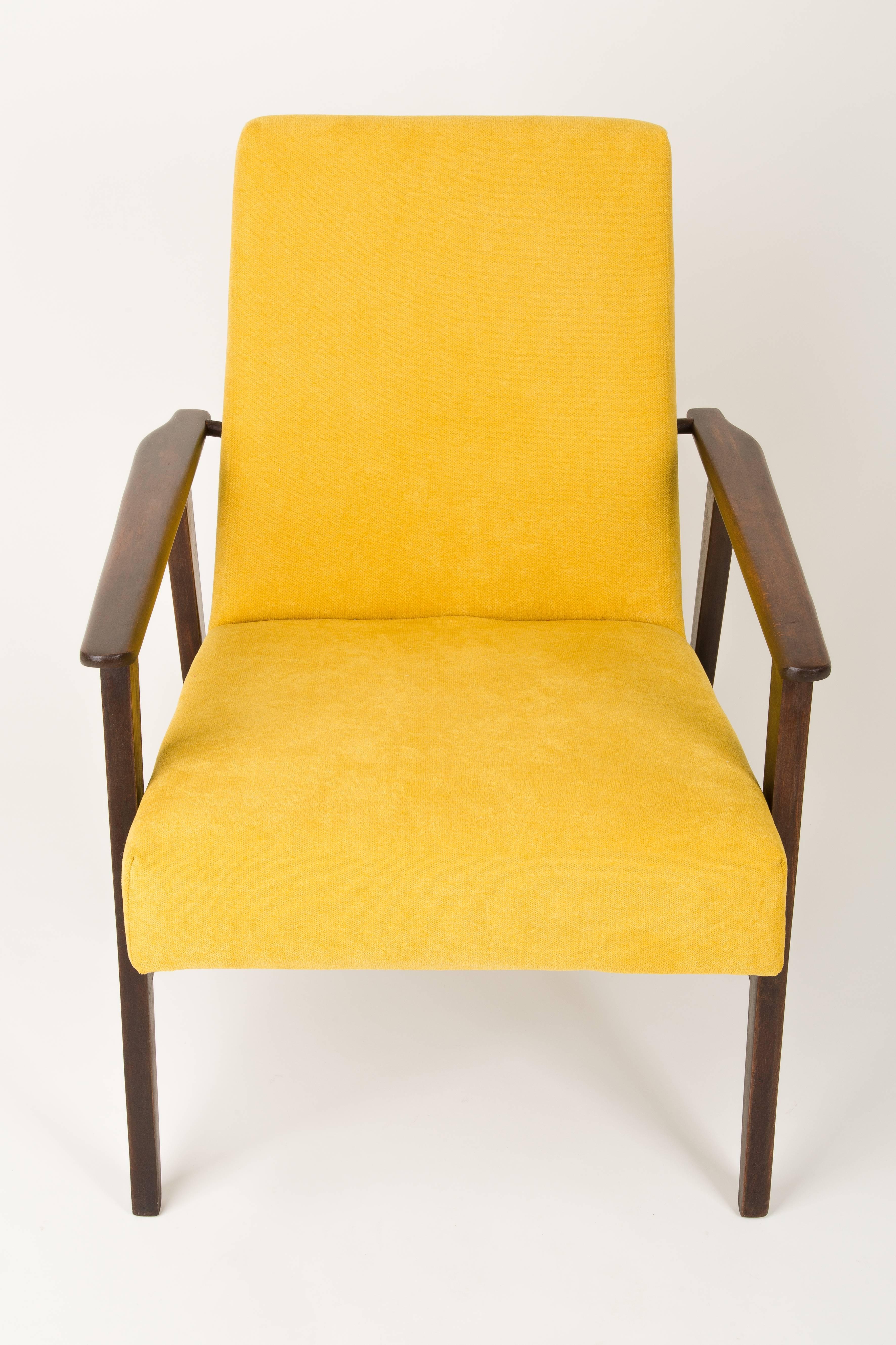 A beautiful, restored armchair designed by Henryk Lis. Furniture after full carpentry and upholstery renovation. The fabric, which is covered with a backrest and a seat, is a high-quality velour upholstery. The armchair will be perfect in minimalist