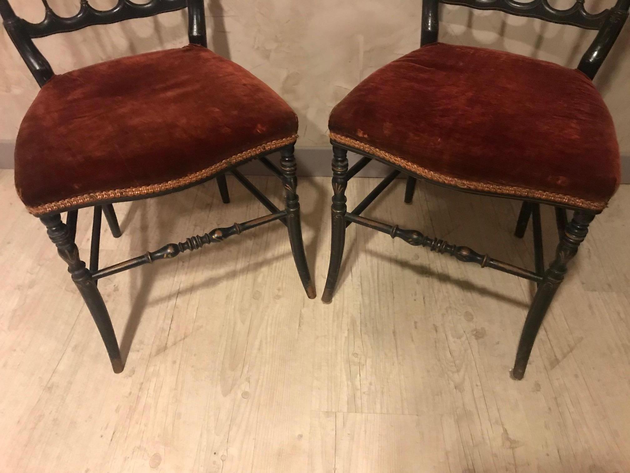 Beautiful 20th century French Napoleon III style pair of chairs.
Red velvet seating that has to be changed but can be used like that as well. 
Very nice black Napoleon patina and golden details.
Ideal in a bedroom of in a hall.
Nice quality.