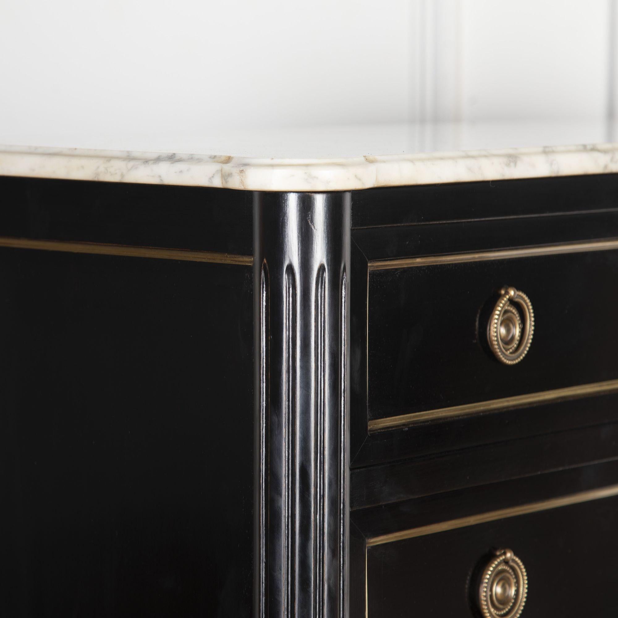 Elegant early 20th Century mahogany framed ebonised semainier with seven equally sized drawers. 
Of French origin, circa 1930, this semainier features its original white marble and ormolu mounts. 
Within today's home, this piece would make for