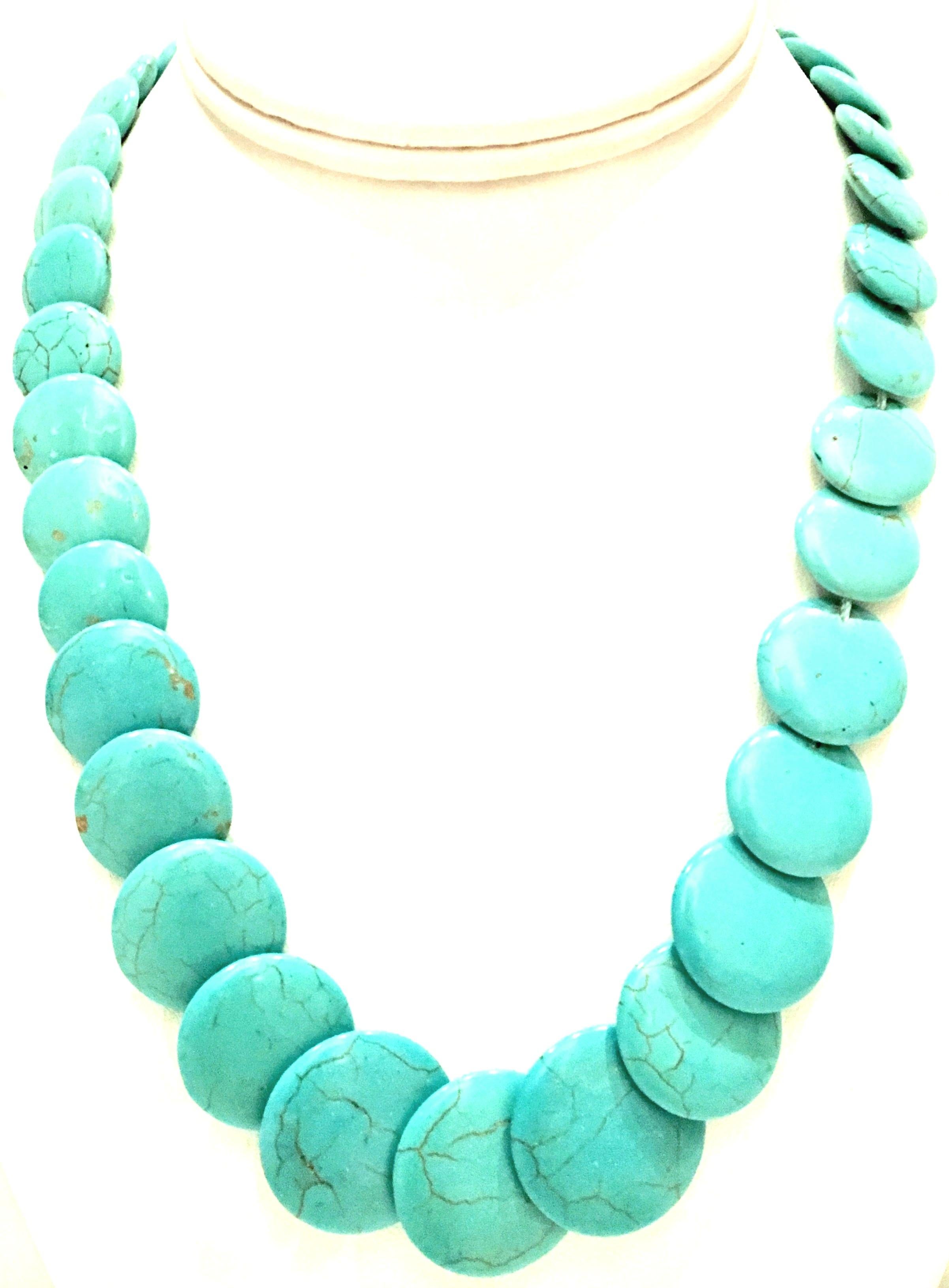 20th Century Classic & Timeless Authentic polished turquoise graduated bead, disc shaped necklace. The largest turquoise beads measure 1' inch diameter. Total weight 62 grams. The locking clasp is silver rhodium plate.