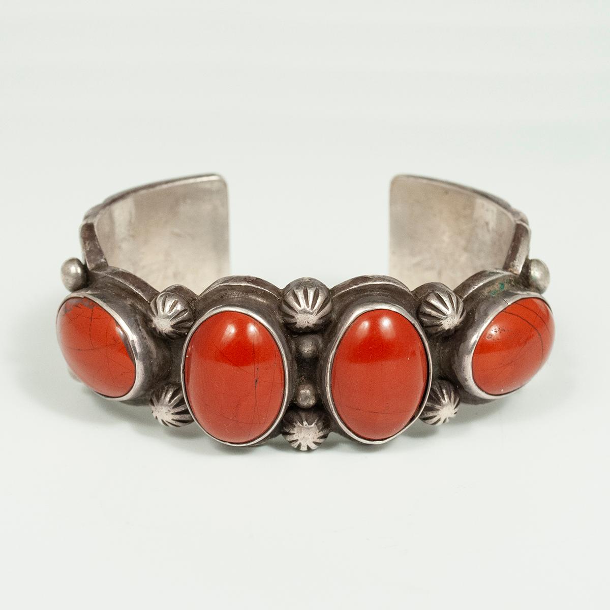 20th century Navajo silversmith Sadie Calvin Jasper and Silver bracelet

Four gorgeous red jasper cabochons are set in this nicely stamped silver bracelet by Sadie Calvin (Dine), a silversmith for the distinguished jewelry company B. G. Mudd of