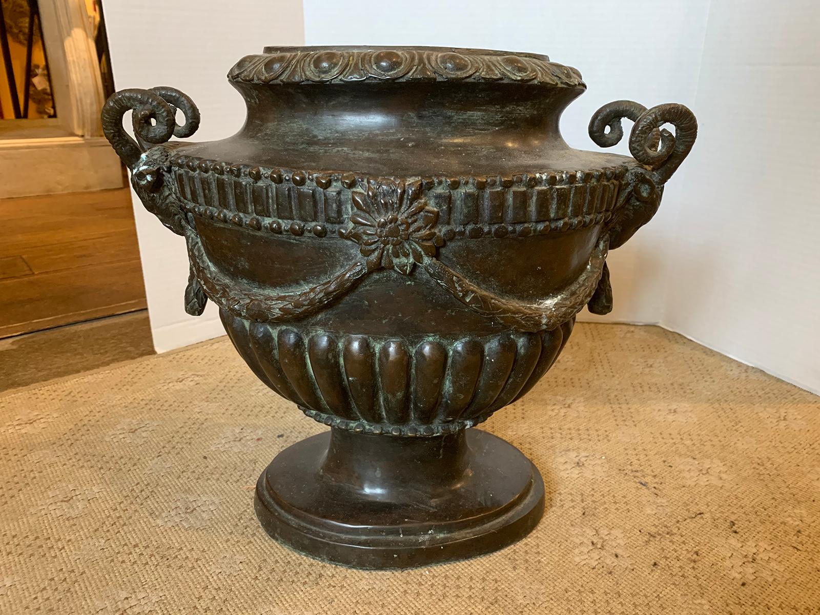 20th century neoclassical oval bronze urn with rams heads.