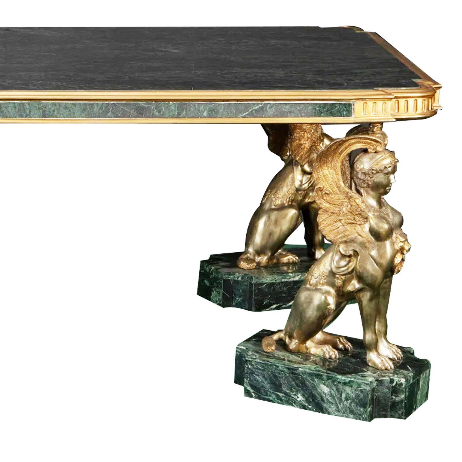 Neoclassical-style library table, 20th century.
 

The top with bronze border and inset marble raised on four seated winged lion legs on marble plinths
 
Dimensions

31