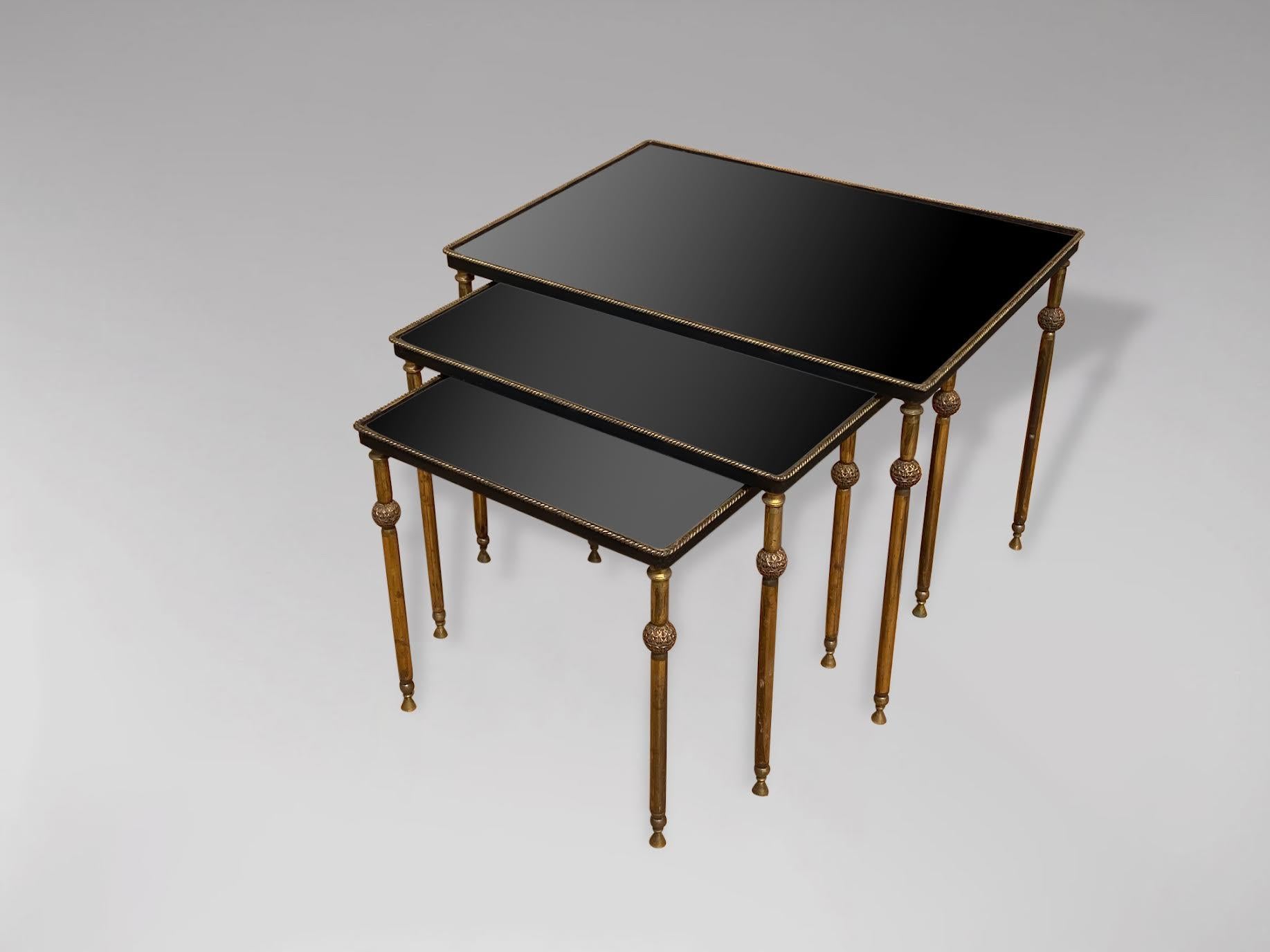 A stunning set of 3 mid 20th century rectangular brass frame nest of tables with inset black lacquered mirror tops. In very good vintage condition. These tables were made in France and date from around the 1950s. 

Dimensions of the large table