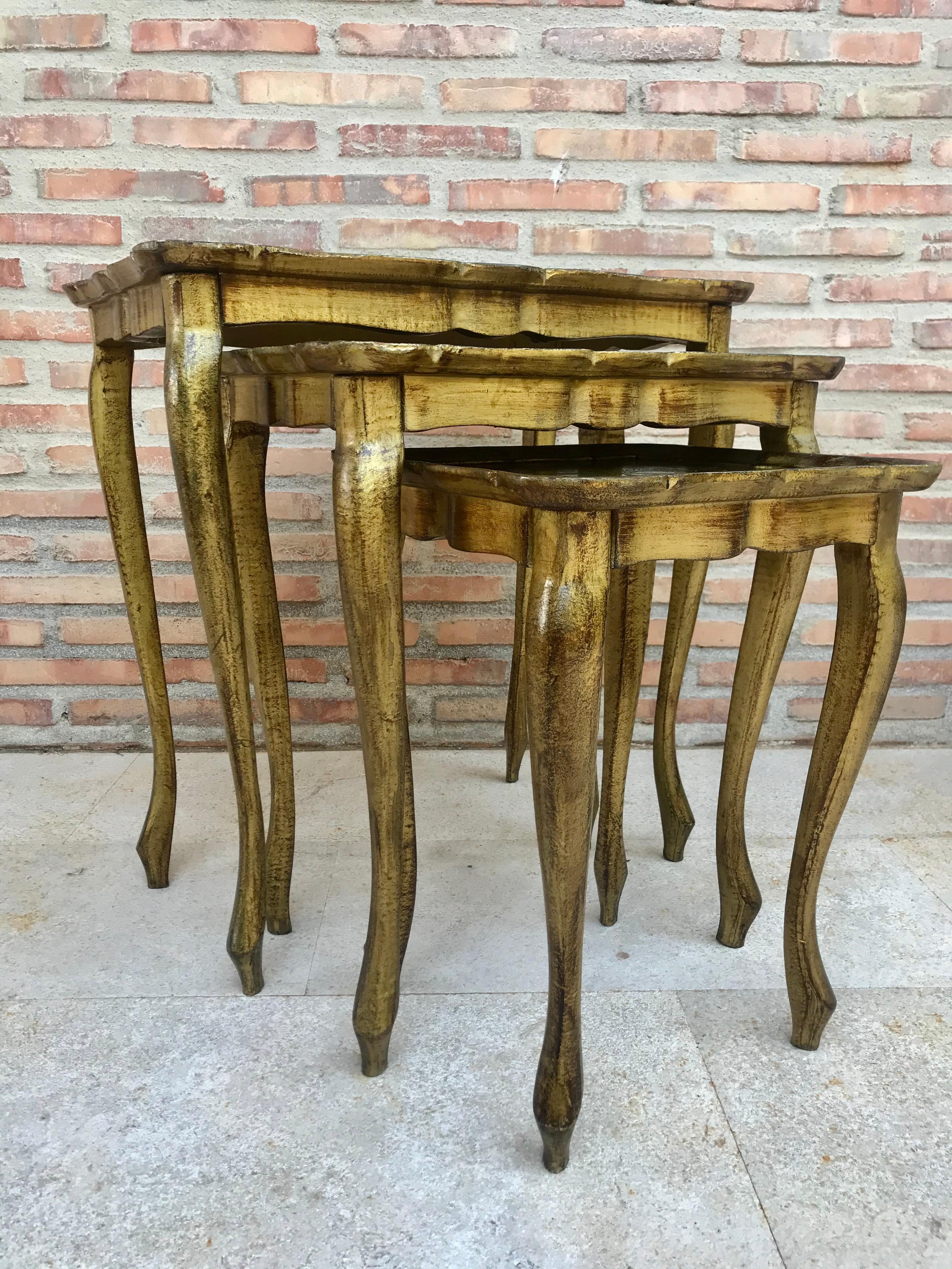 This stylish nest of 3 giltwood side tables feature slender cabriole shaped legs and handmade green paintings.

Measures: Depth 14.17in, width 21.65in, height 22.83in
Depth 12.59in, width 16.92in, height 20in
Depth 12.8in, width 12.8in, height