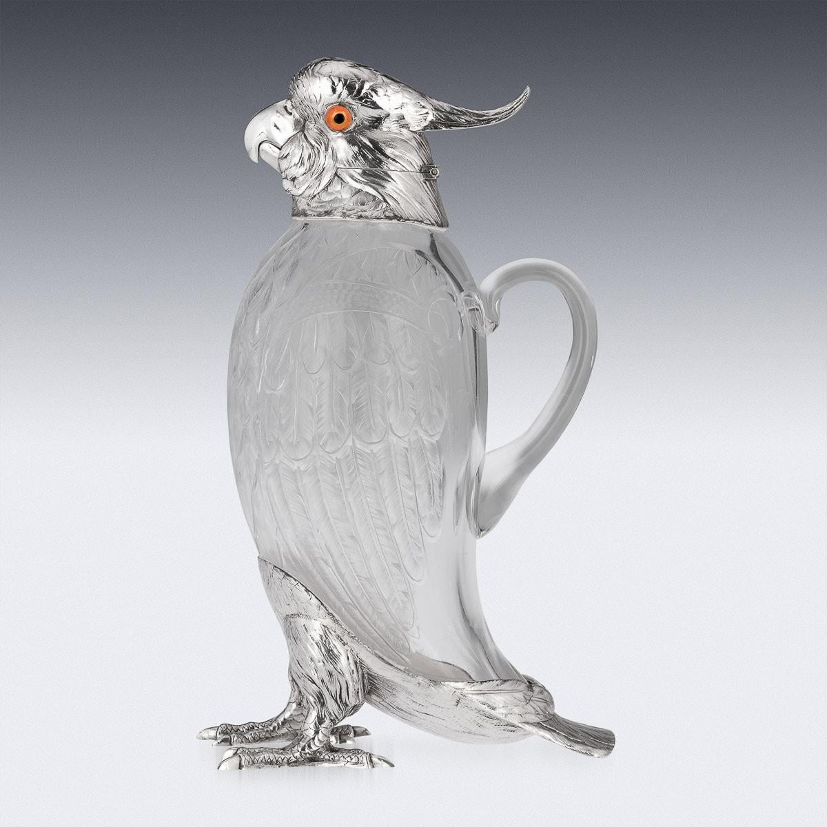 20th Century English silver and cut glass mounted novelty wine jug, in the form of a standing cockatoo, set with coloured glass eyes and translucent glass body imitating textured plumage, mounted with a realistically modelled silver head and