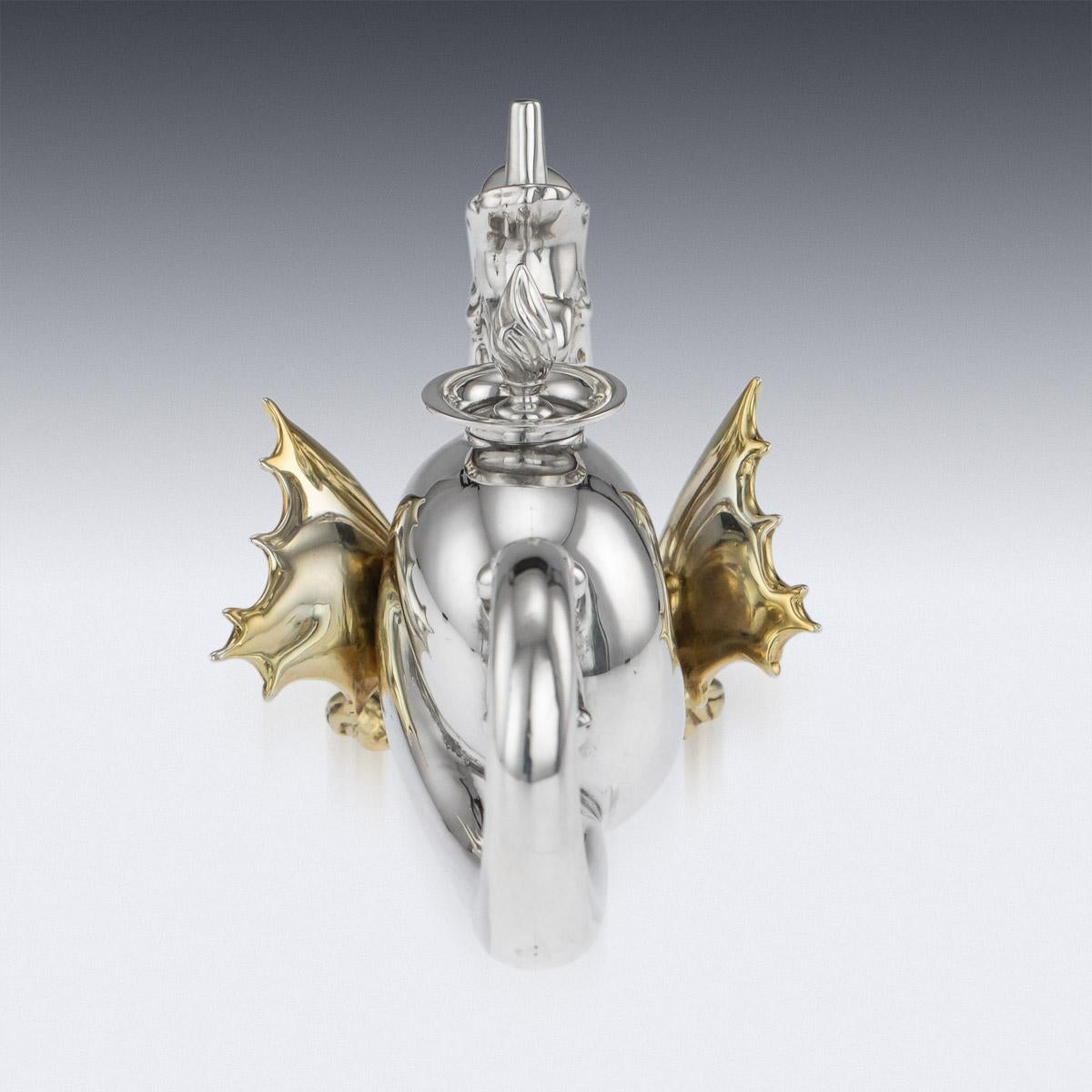 Antique 20th century novelty solid silver cigar light, unusually shaped as a dragon, the raised head forming the light and the tail forming the handle, applied with gilt wings and feet. Hallmarked English Silver (925 Standard), Birmingham, year 1923