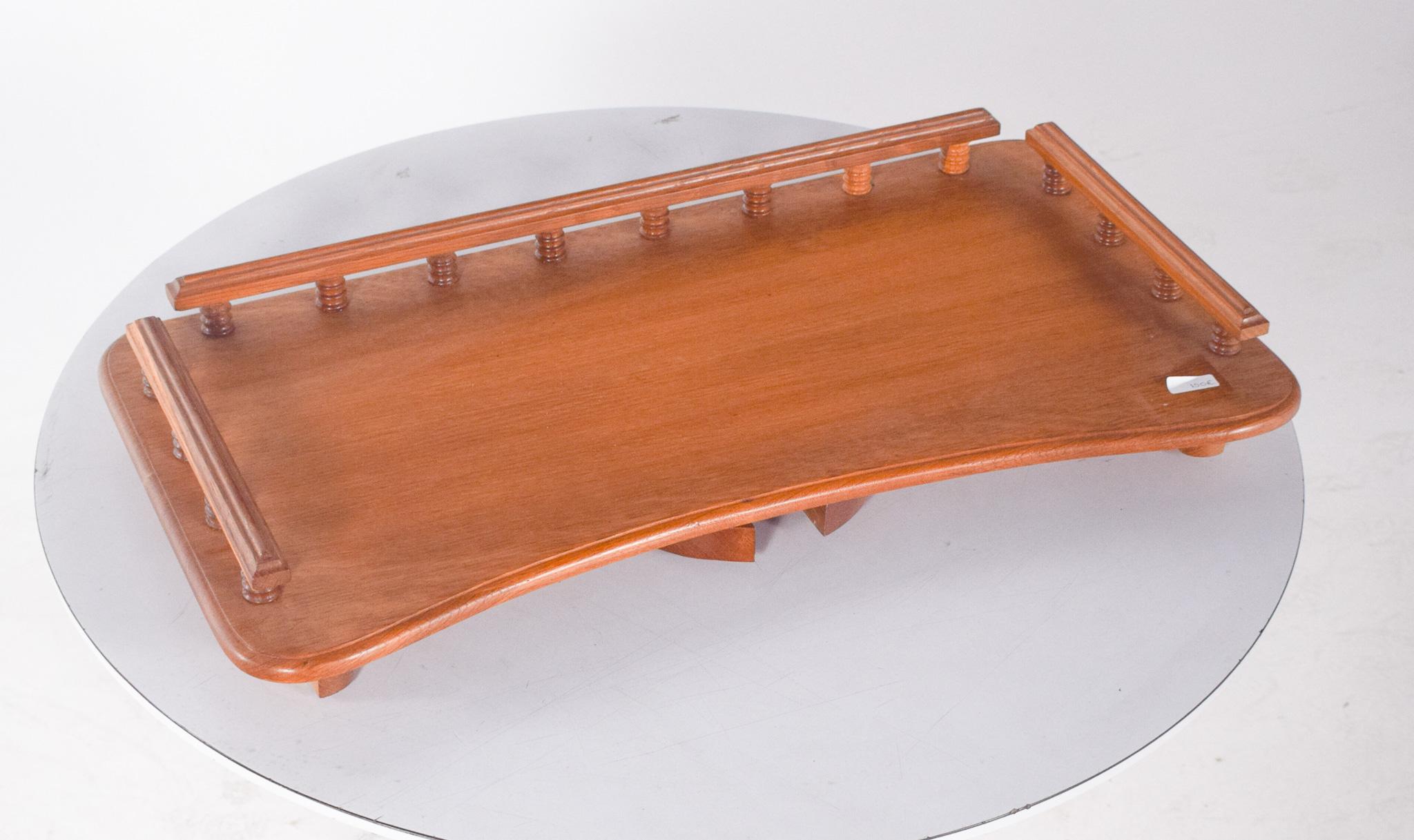 Oak bed tray. Characterised by detailed workmanship, it has a rectangular top with gently rounded corners and a worked frame, supported by four turned legs with concentric rings, a style reminiscent of traditional furniture. The side and back