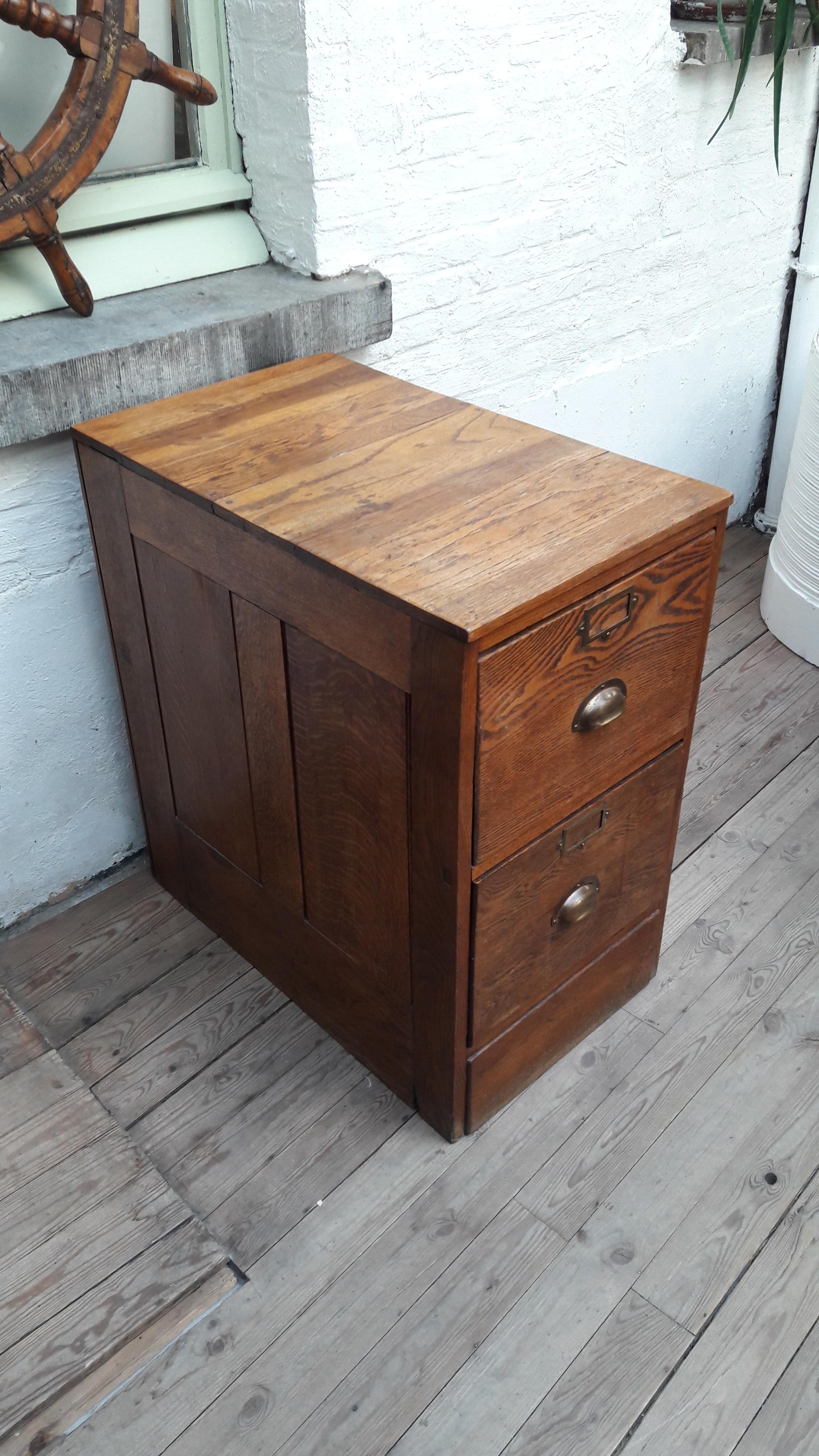 1930s English oak filing cabinet with brass handles. Great warm colour of the wood.
