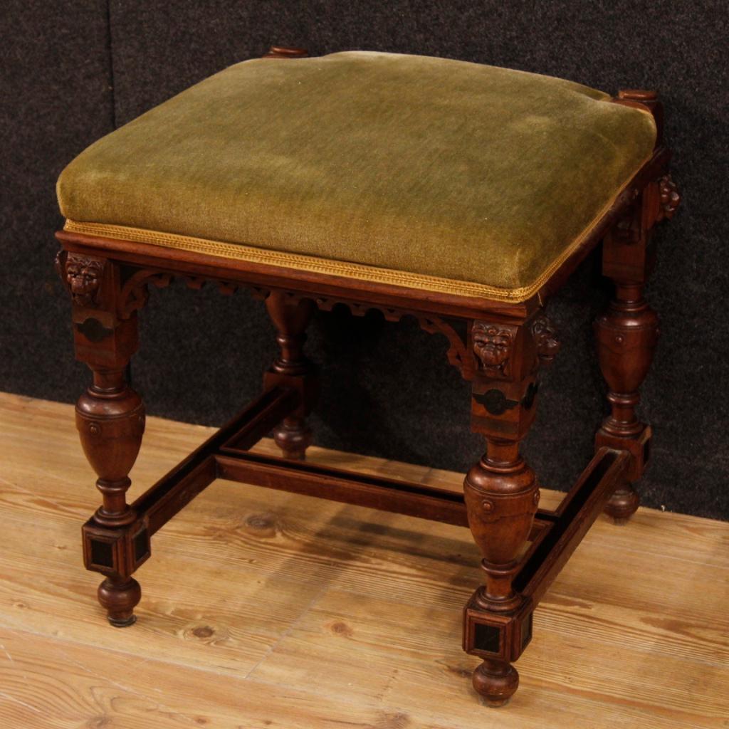 Dutch stool from the first half of the 20th century. Pleasantly carved furniture in oakwood with ebonized elements and leonine heads. Footstool covered in velvet with some small signs (see photo). Furniture of good comfort with height to the seat of