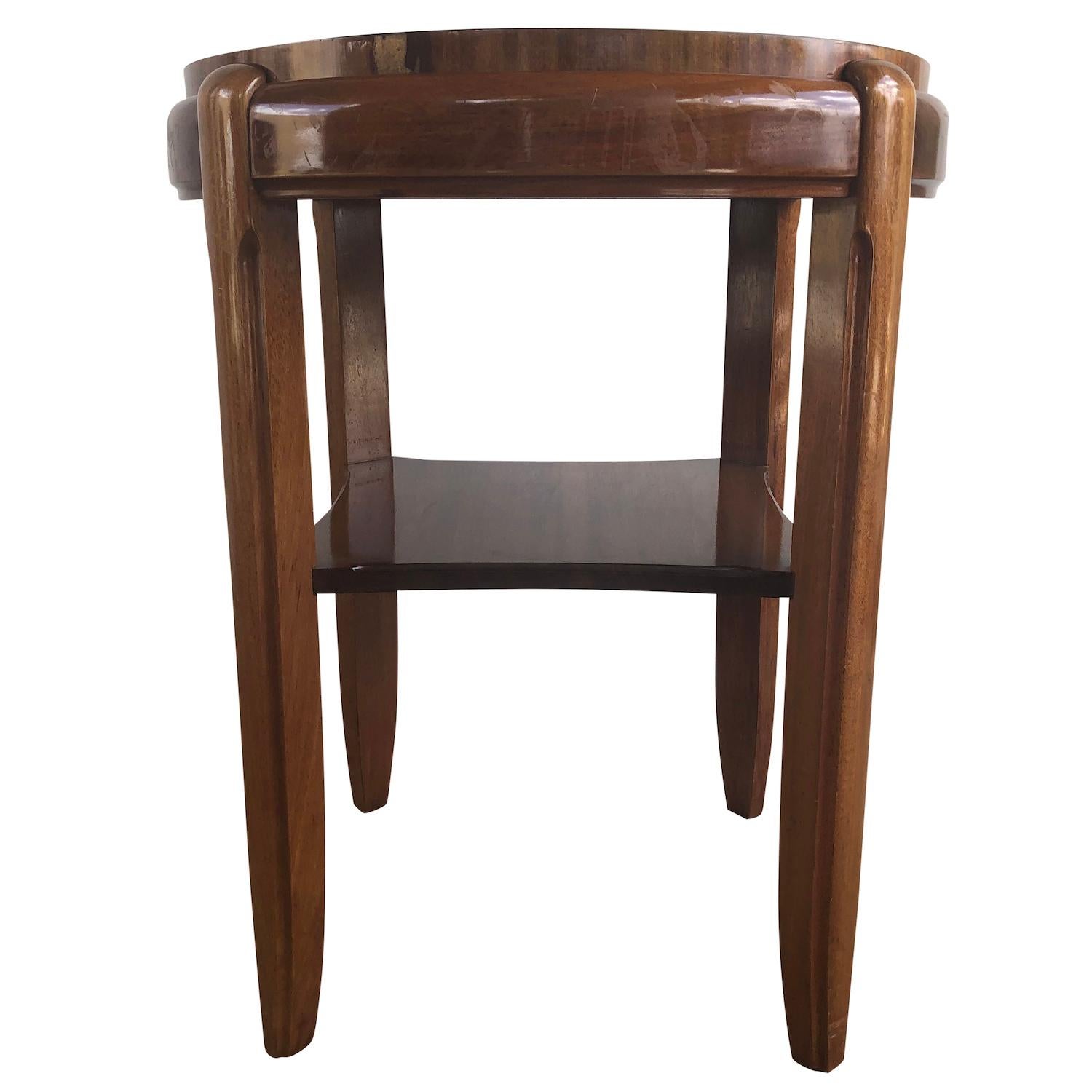 A dark-brown, vintage Art Deco Italian round side table made of hand crafted Mahogany with a light brown leather top, in good condition. Wear consistent with age and use. Circa 1930, Italy.