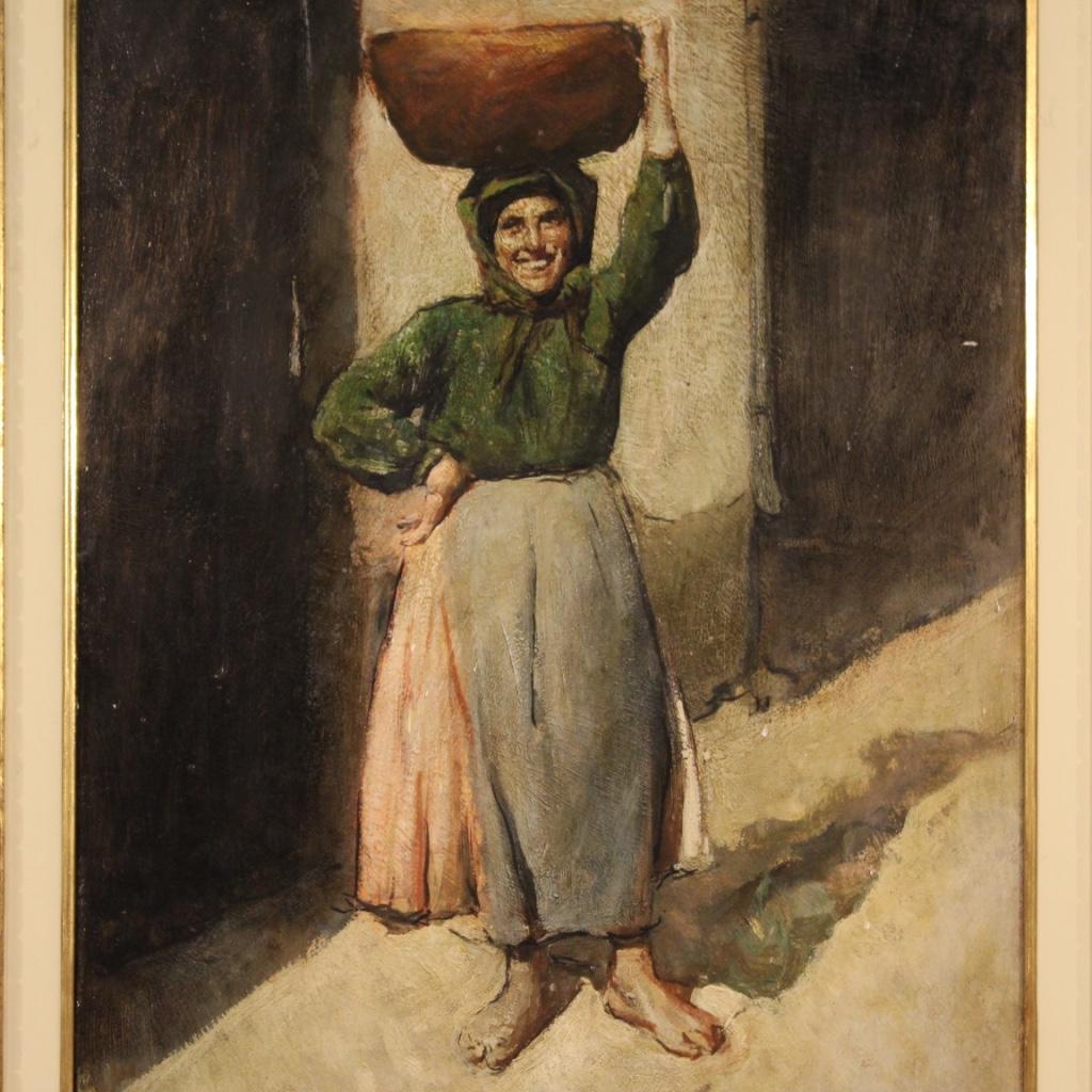 Italian painting from the first half of the 20th century. Framework oil on board depicting Peasant woman with basket of good pictorial quality. Finely carved and gilded wooden and plaster frame equipped with a painted wooden passe-partout (see