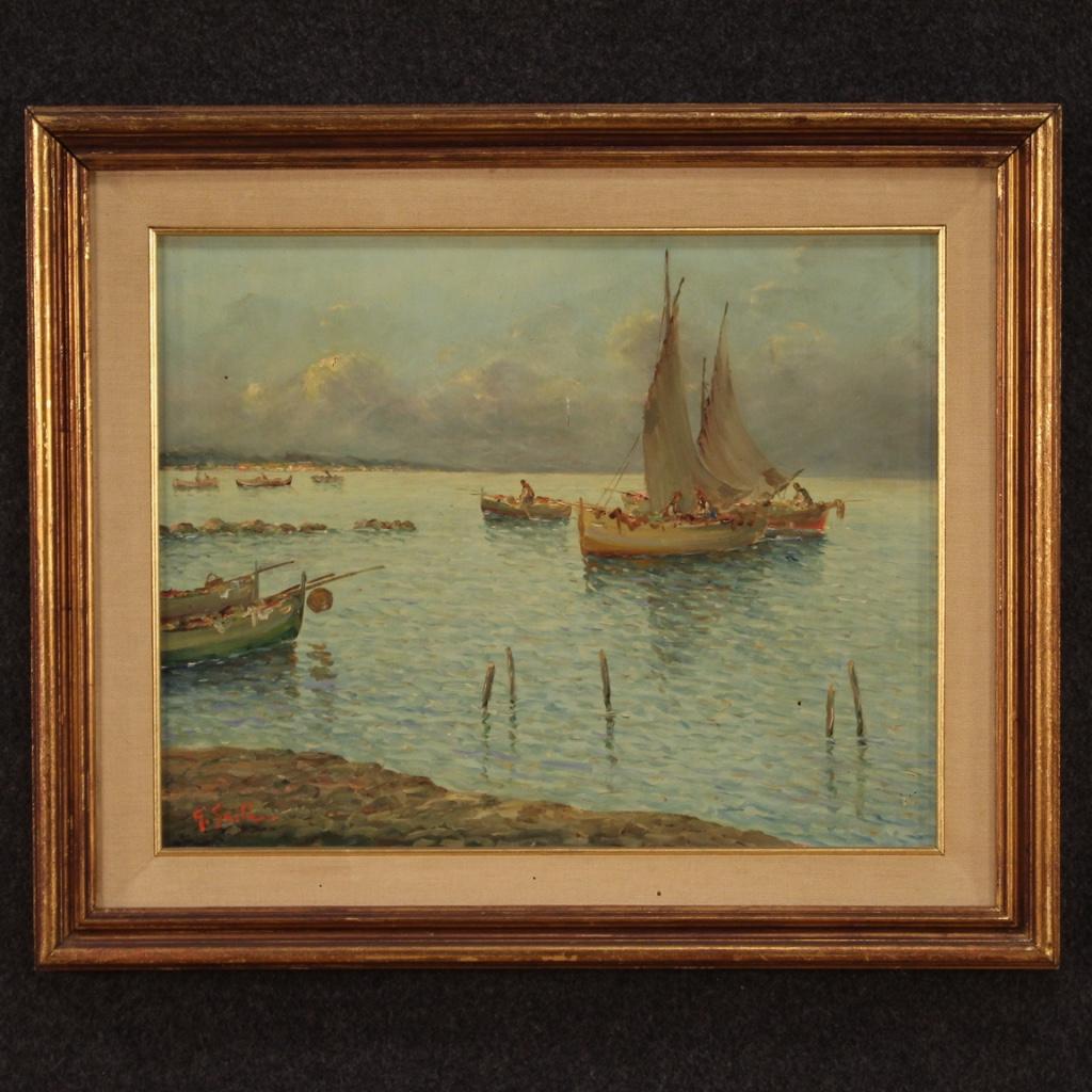 Italian painting of the 20th Century. Work oil on board depicting Seascape with boats of good pictorial quality. Painting of good brightness adorned with a carved and gilded wooden frame with a canvas passe-partout (see photo) with three small holes