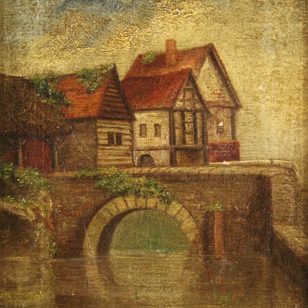 Small English painting from the first half of the 20th century. Framework oil on canvas depicting a landscape on the river with houses and a bridge of rustic character. Modern frame in wood and composite material richly chiseled, gilded and adorned