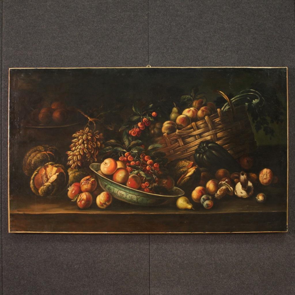 Still life with fruit from the mid-20th century. French oil on canvas artwork depicting a splendid composition of fruit on a dark background, of good pictorial quality. With great naturalism the fruits of the four seasons (peaches, mushrooms,