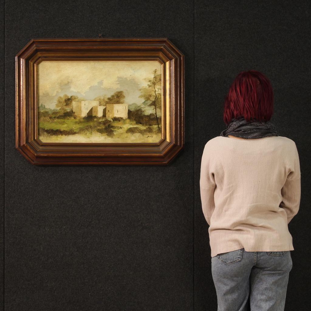 Italian painting from the second half of the 20th century. Artwork oil on masonite depicting a view with small houses in the green of good pictorial quality. Painting adorned with an octagonal wooden frame carved and enriched with golden reflections