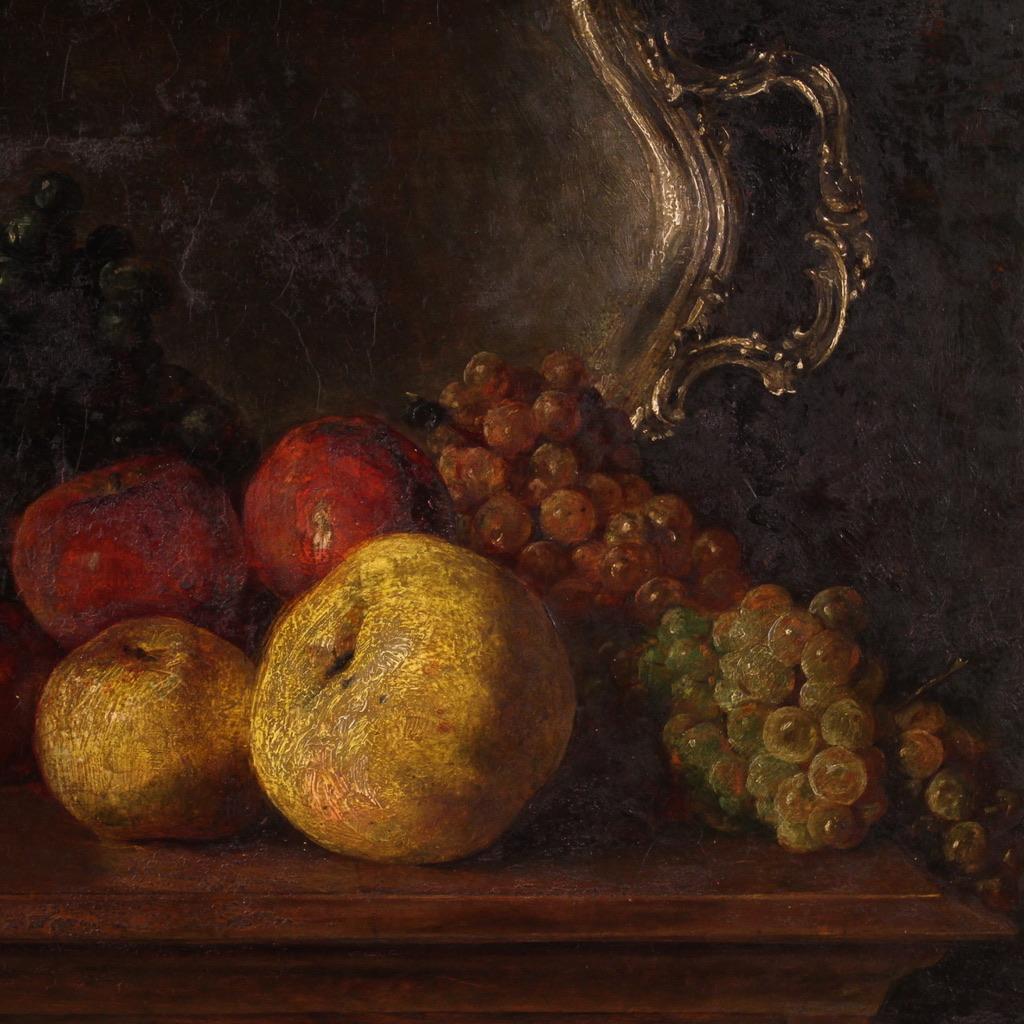 Italian painting from the first half of the 20th century. Artwork oil on panel depicting still life with fruit, tray and goblet of wine of good pictorial quality. Framework of beautiful size and proportion adorned with a coeval wooden frame carved