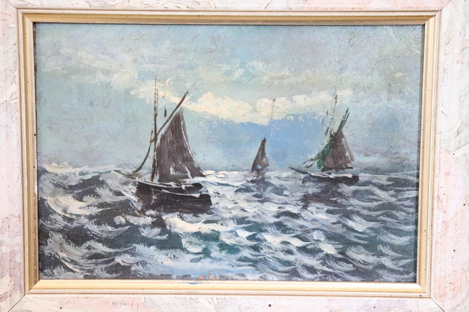 Italian oil painting on hardboard beautiful seascape with boats excellent pictorial quality. Note how the colors contribute perfectly to make the emotion of a stormy sea. Sold with recent frame.