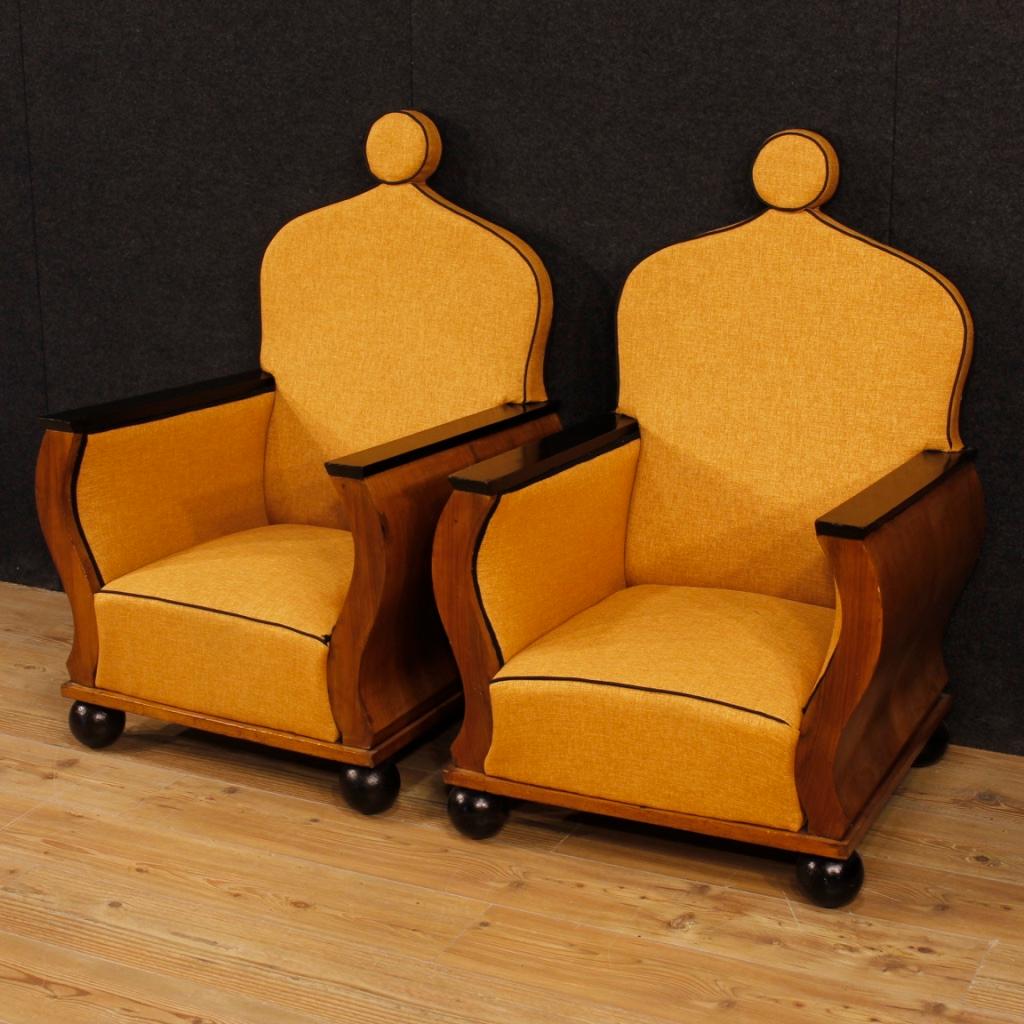 Pair of French armchairs from 20th century. Furniture of particular design and construction in walnut with ebonized elements (feet and armrests) of excellent quality. Armchairs upholstered in fabric (recently replaced) with some small signs (see
