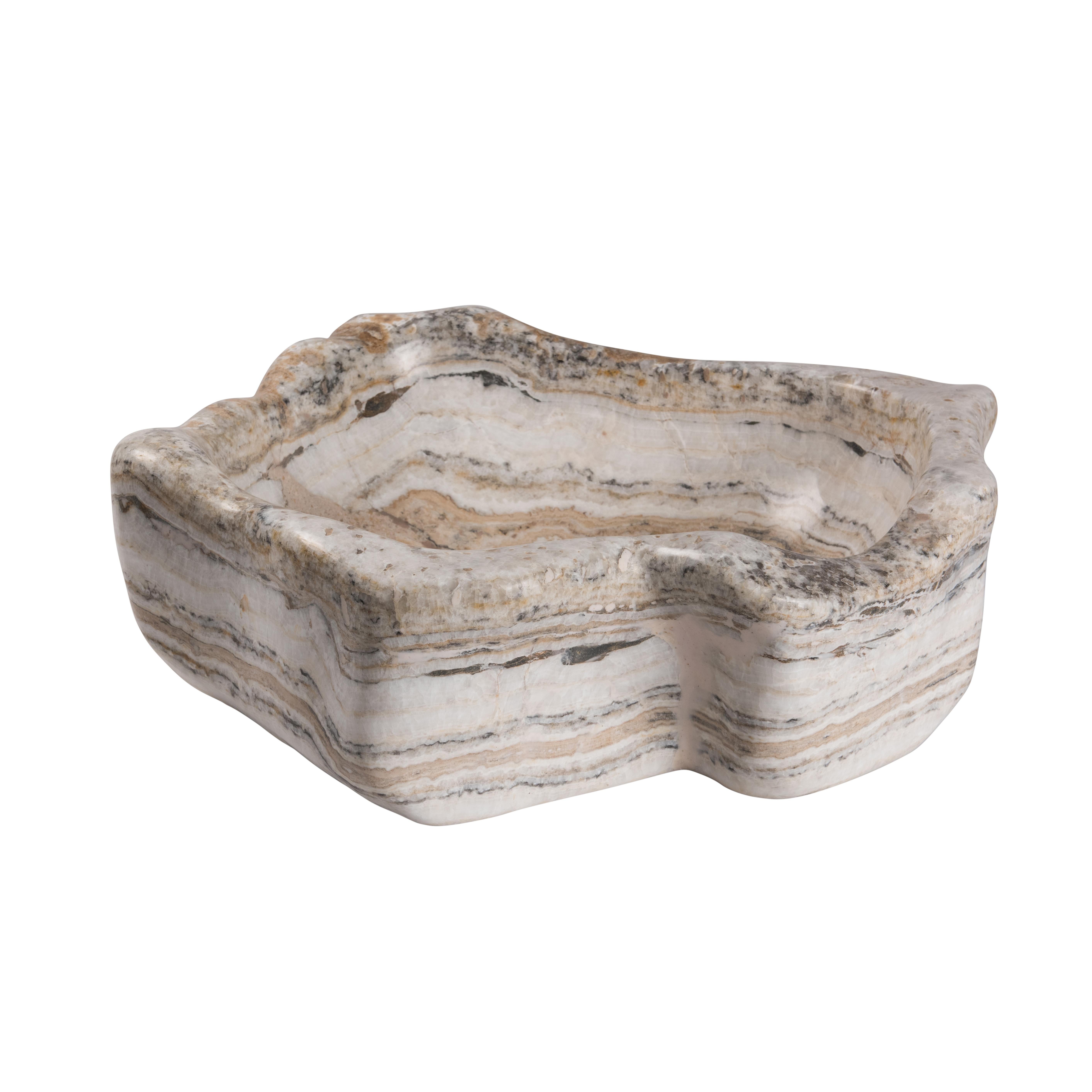 One of a collection of Onyx basins, polished to perfection, adding a touch of organic opulence to any room. The hand polished bowl makes it suitable for either a basin or a decorative object that will create a real focal point in any setting.