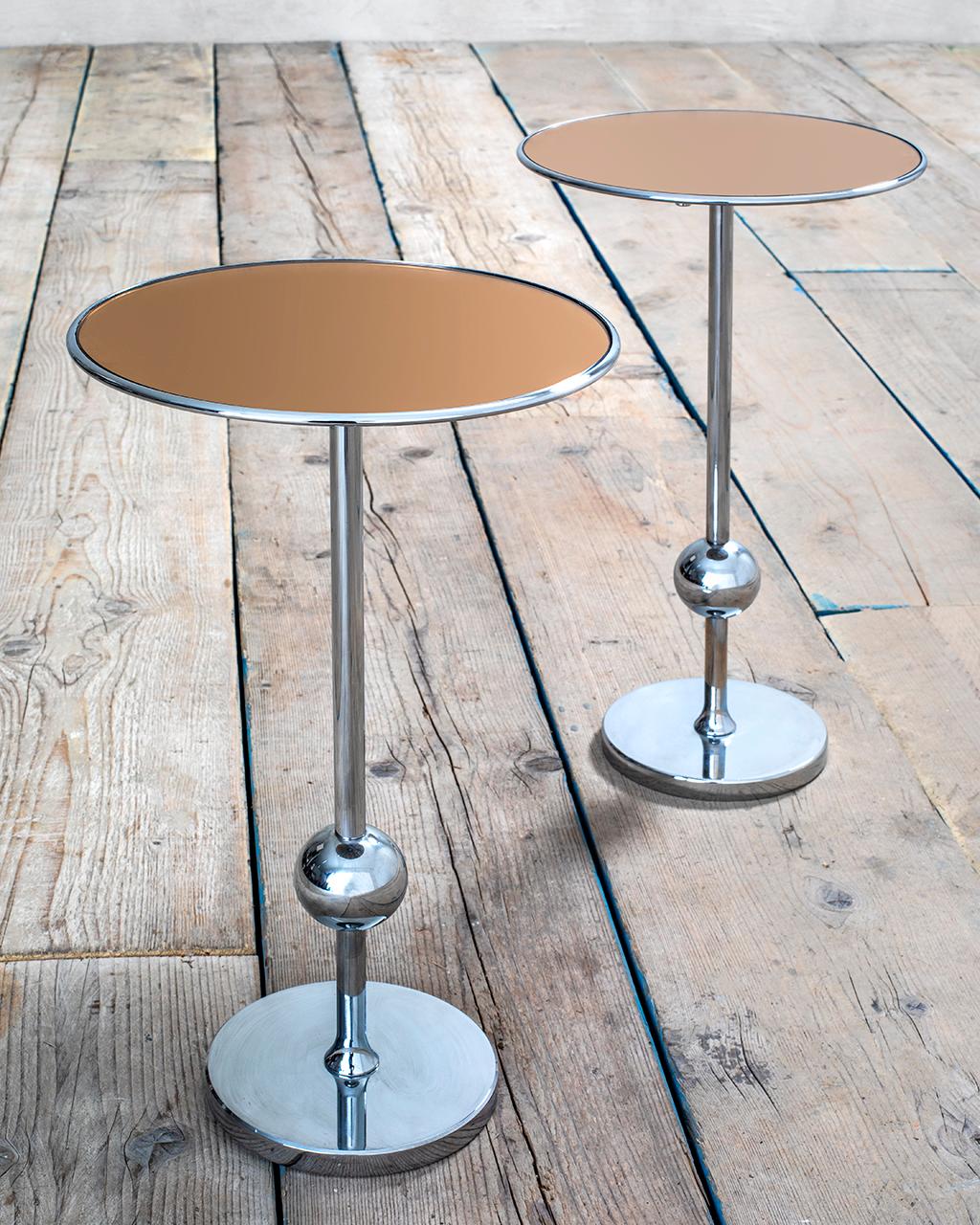 Pair of side tables or low tables model T1 by Osvaldo Borsani for Tecno. Osvaldo Borsani designed these pieces of furniture between 1948 and 1950. T1 is 45 centimeters high and has a chromed steel structure with the characteristic globe. 
The top