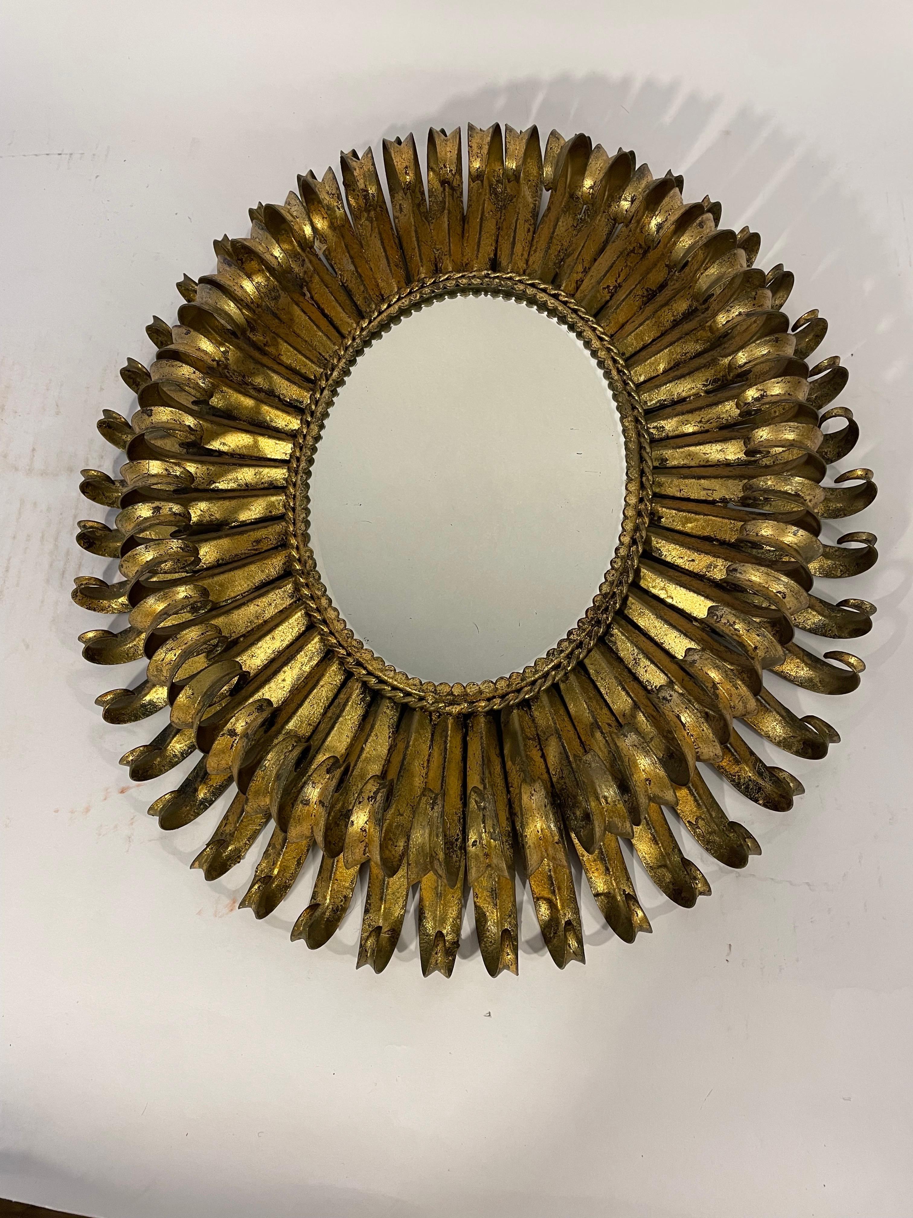 An oval gilt metal eyelash mirror from Spain