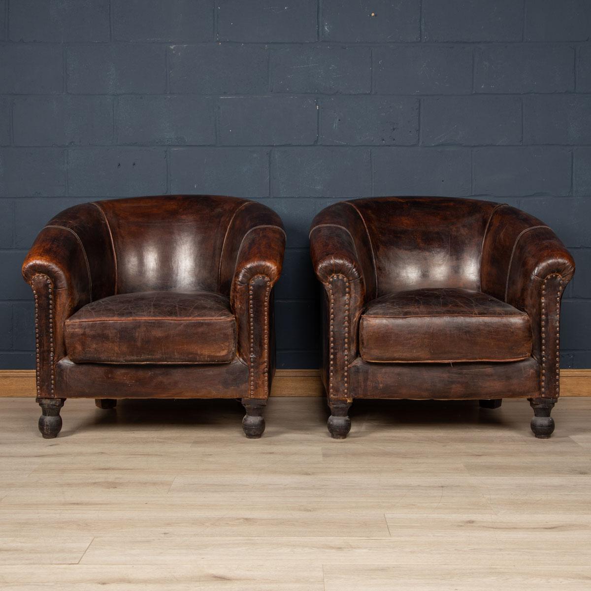 Showing superb patina and colour, this wonderful pair of tub chairs were hand upholstered sheepskin leather in Holland by the finest craftsmen in the latter part of the 20th century. This particular set is oversized, probably a custom
